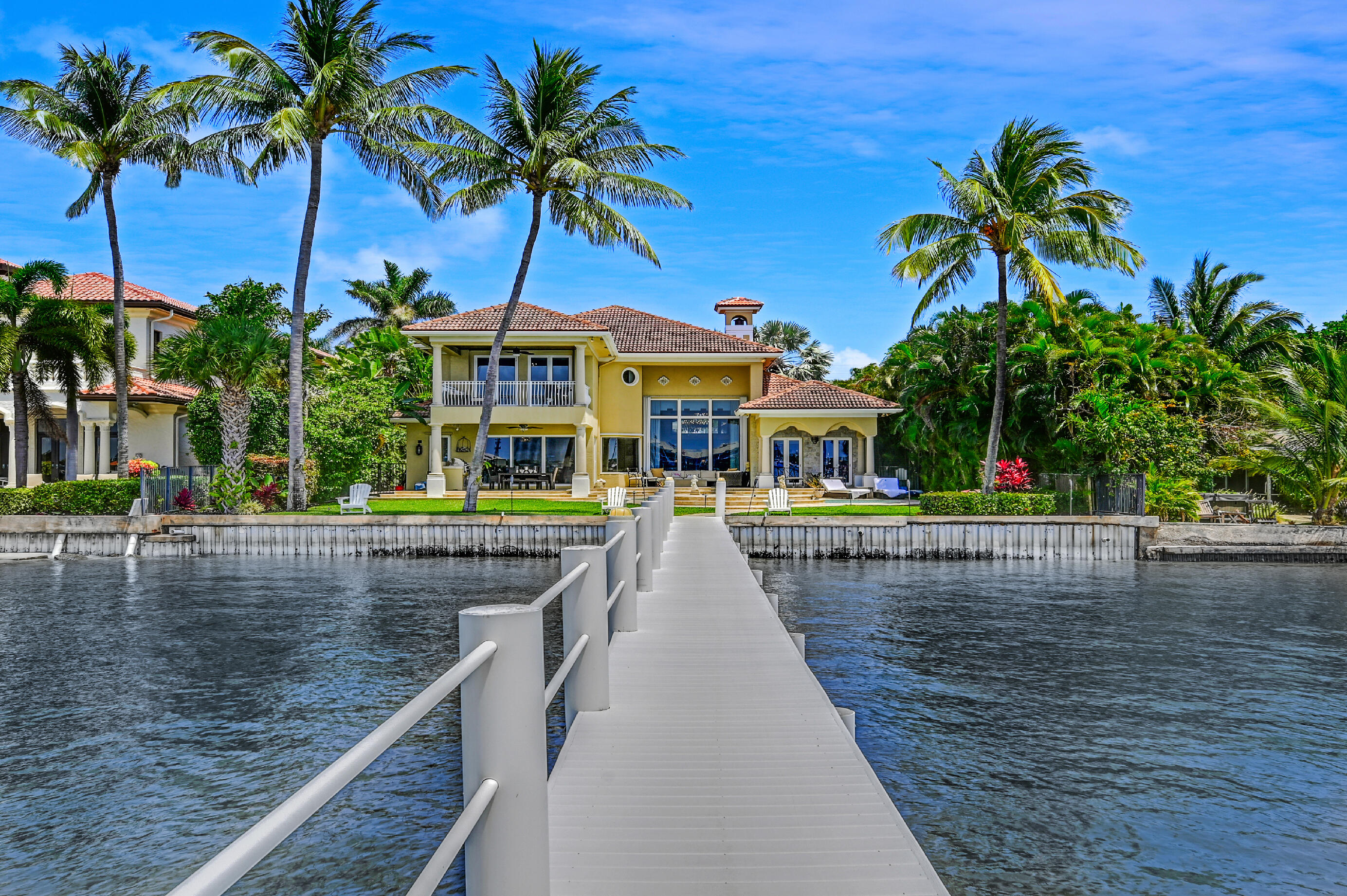 Boater's dream waterfront estate set on one of the widest points on the intercoastal minutes from inlet in the exclusive beach enclave of Hypoluxo Island within short walking distance to the ocean and The Palm Beach Eau Resort and Spa Hotel. This spacious 2 story, 4 bedroom & 4.5 bath family home stretches out at over 6,100 sq. ft. with over 4,600 sq. ft. of living space. Store your large yacht on the newer 26,000 lbs. boat lift complete with electric and water. Relax in your newly remodeled roomy outdoor kitchen with refrigerator will keep your drinks cool as you relax and sunbath on the patio. 24ft. ceilings and immediate expansive view of the intracoastal. First floor has a primary or guest bedroom suite. Open floor plan with large eat in kitchen and family room with fabulous water views throughout. Second floor include 3 additional bedrooms with ensuite bathrooms. Second-floor Primary bedroom suite has large his and her closets, walk-in shower, jacuzzi. Sip your morning coffee on the spacious 2nd floor patio overlooking the Intracoastal Waterfront.