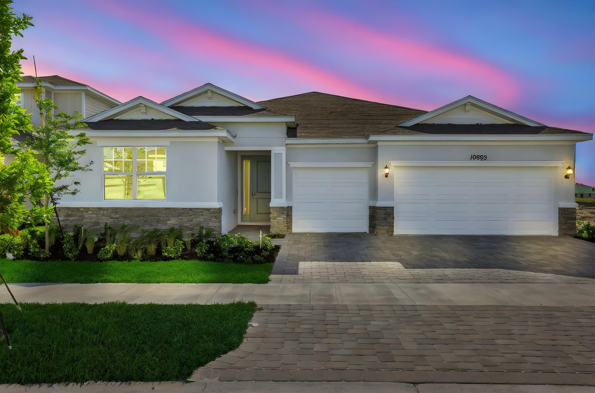 The Catalina, a stunning single-story home featuring 3 bedrooms, 2 bathrooms, which feature double vanity sinks, and a spacious 3-car garage within 2,211 square feet of thoughtfully designed living space. The open-concept kitchen includes a large island and flows effortlessly into the living and dining areas, creating a bright and inviting space perfect for both relaxing and entertaining. A separate dining space off the great room a more formal setting for meals and gatherings. The primary suite includes an expansive walk-in closet for ample storage and a connected private bathroom. Multiple windows throughout the house fill every room with natural light, enhancing the open and airy feel. A lanai extends your living space outdoors, offering a seamless connection to fresh air and nature.