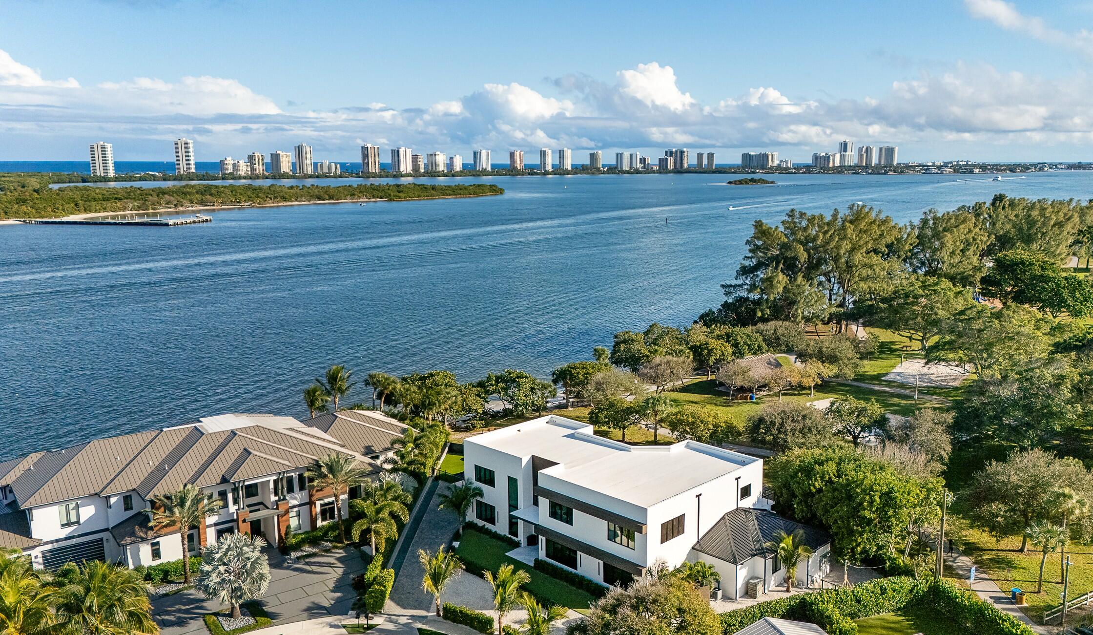 Newly completed, this exceptional coastal modern estate in North Palm Beach offers expansive Intracoastal water views from nearly every room. Designed for luxury entertaining, the home features 5 oversized en-suite bedrooms & over 7,800 SF of open, light-filled living. A chef's kitchen anchors the home, complemented by a expansive great room, private theater, sophisticated bar, gym, office, and elevator. Seamless indoor-outdoor living with a resort-style pool, spa, summer kitchen, and multiple entertaining areas. The extended garages are lift-ready, accommodating up to four vehicles plus a golf cart. Prime location near world-class marinas, championship golf courses, fine dining, upscale shopping, & pristine beaches, offering the ultimate South Florida waterfront lifestyle.