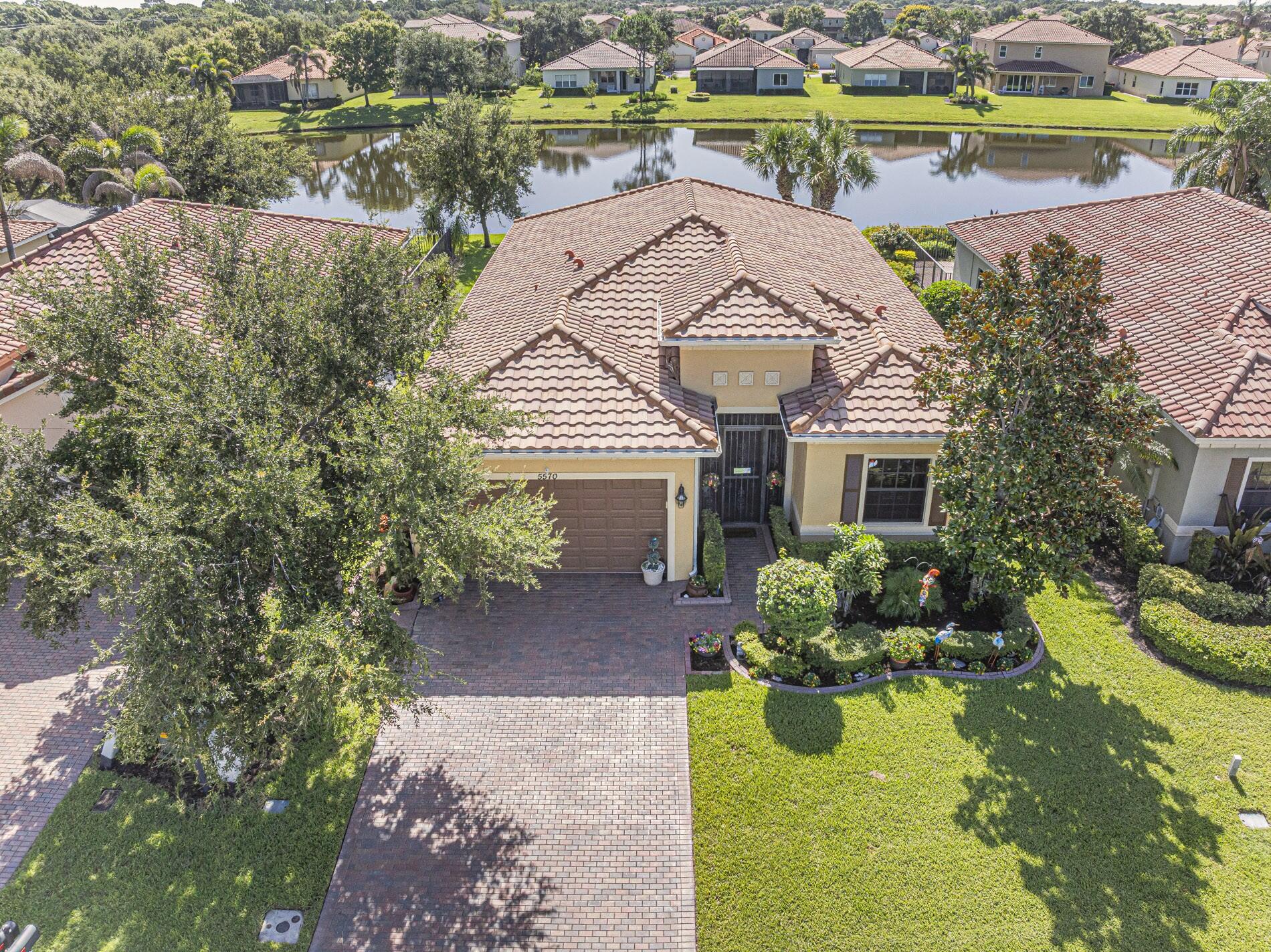 Come see this wonderful former model home in VeroLago. The desirable 3/2 Monticello model feature a beautifully landscaped lakefront lot, IMPACT WINDOWS, 10' ceilings and 8' doorways, large chef's kitchen w/ a large island, extended screened patio, crown molding and so much more. With low HOA fees, this gated community feature all lawn care, gym, heated community pool, lighted tennis/pickleball courts, and a kids play area. This perfect Florida dream home is close to beaches, shopping and restaurants.