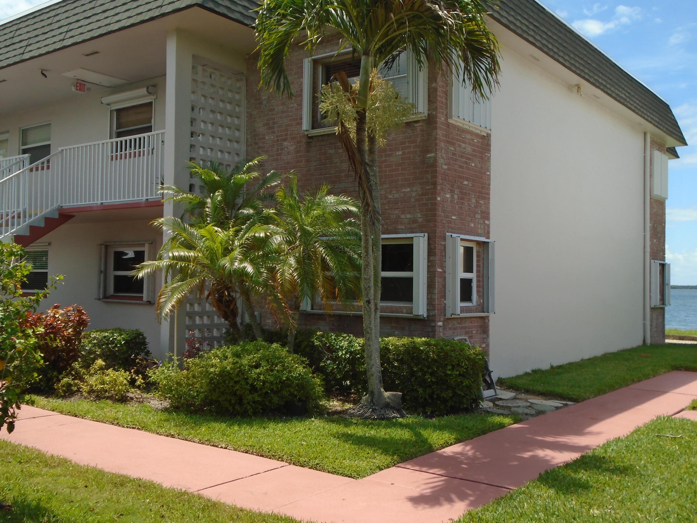 Beautiful waterfront first floor corner unit. Great water view, step outside and start fishing. Unit is across from the clubhouse just steps to the pool. Features all tile floors, air-conditioned lanais with impact windows and doors. Textured walls and ceiling. Accordion shutters on windows. Recently installed garbage disposal 5/26, roof 8/24, water heater 8/23, AC  3/22. Clubhouse has new roof, the pool and deck area done in 2026. Marina docks subject to availability, storage yard for boats, trailers or vehicles. Clubhouse features pool tables, exercise equipment, library, TV, dance floor, meeting room and office. All figures are approximate.