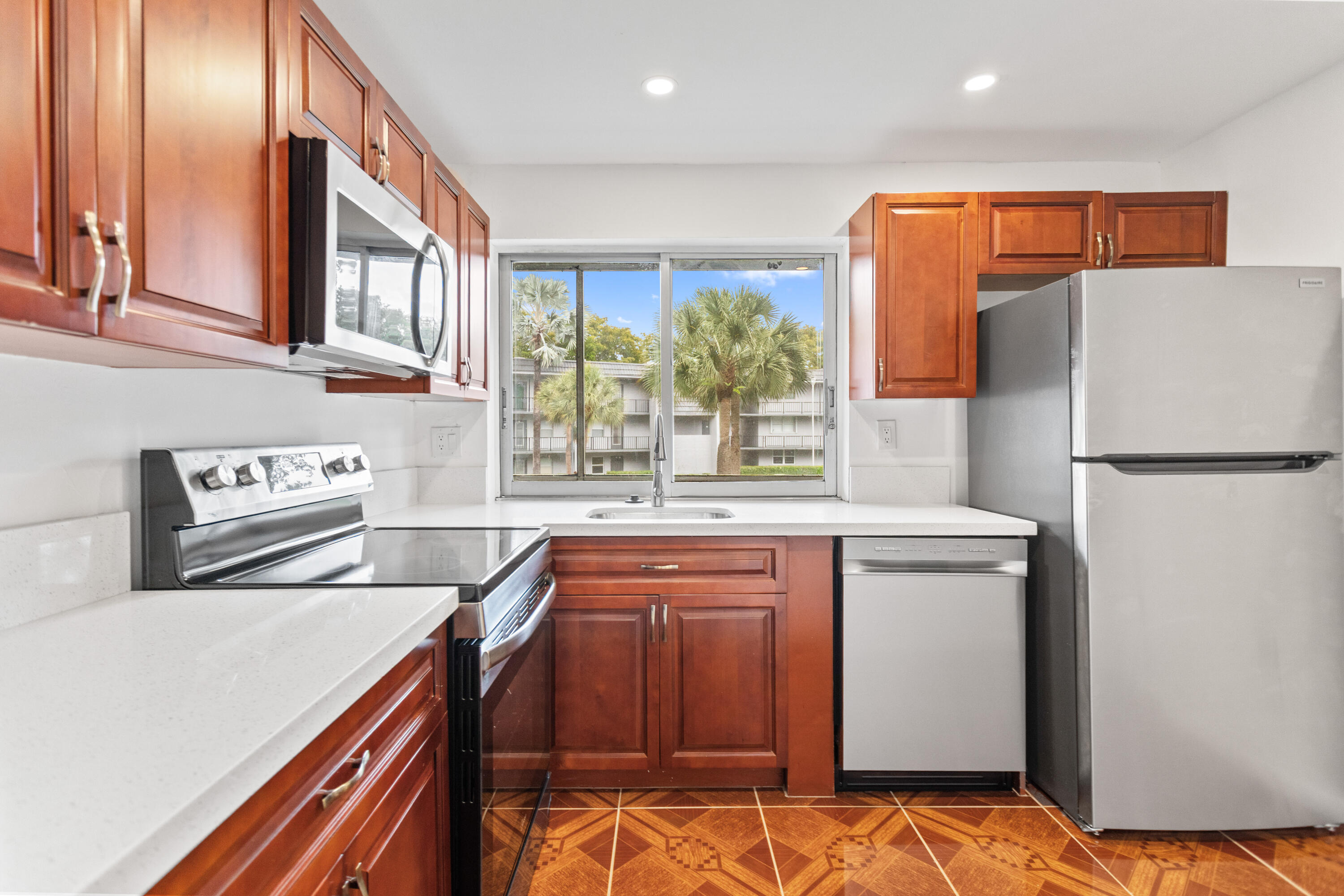 Beautifully update home. The kitchen with sleek quartz countertops and brand-new stainless steel appliances. Fresh interior paint and laminated flooring throughout the main living areas, creating a bright and inviting atmosphere. Brand-new A/C system installed in April 2026 and a new roof. The exterior was freshly painted in January 2026, adding to the home's curb appeal.  Located in a well-maintained community with no special assessments and strong HOA reserves. Enjoy access to fantastic amenities including a pool, clubhouse, tennis courts, and more. Building has an elevator. Maintenance includes cable, internet, pest control and water. HOA requirements: Income $30K, credit score 715. Pet friendly. 55 Plus community- At lease one occupant.   Beautifully Updated, Move-In Ready Home!