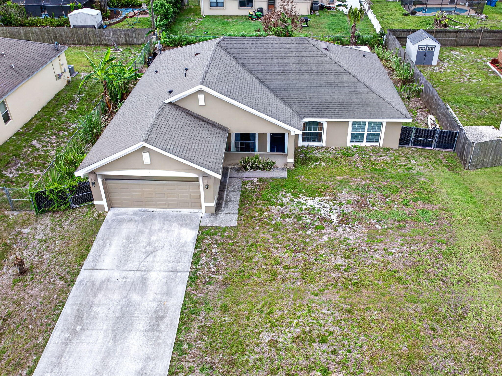 Welcome home to this beautifully maintained 2019-built residence offering over 2,000 square feet of thoughtfully designed living space in the heart of Palm Bay! Featuring 3 bedrooms, 2 bathrooms, and a versatile flex room that can serve as a home office, guest room, gym, or potential 4th bedroom, this home offers the flexibility today's buyers are looking for. Step inside to soaring vaulted ceilings, abundant natural light, and an open-concept layout perfect for both everyday living and entertaining. The spacious kitchen is the centerpiece of the home, complete with a breakfast bar, pantry, ample cabinetry, and a cozy breakfast nook for casual dining. Retreat to the oversized primary suite featuring dual walk-in closets and a spa-like ensuite bath with dual vanities, a soaking tub, separate walk-in shower, and private water closet. The split-bedroom floor plan provides privacy and comfort for guests alike.  One of the standout features of this home is the expansive screened lanai and oversized screened enclosure, creating the perfect outdoor living space to relax, entertain, and enjoy Florida's beautiful weather year-round.  Additional features include a two-car garage, indoor laundry room, storm shutters, and a generous .23-acre lot. Located in Flood Zone X, flood insurance is typically not required by lenders. Conveniently situated near shopping, dining, parks, schools, and major roadways, this move-in-ready home combines modern construction, space, and location.  Schedule your private showing today and discover everything this exceptional Palm Bay home has to offer!
