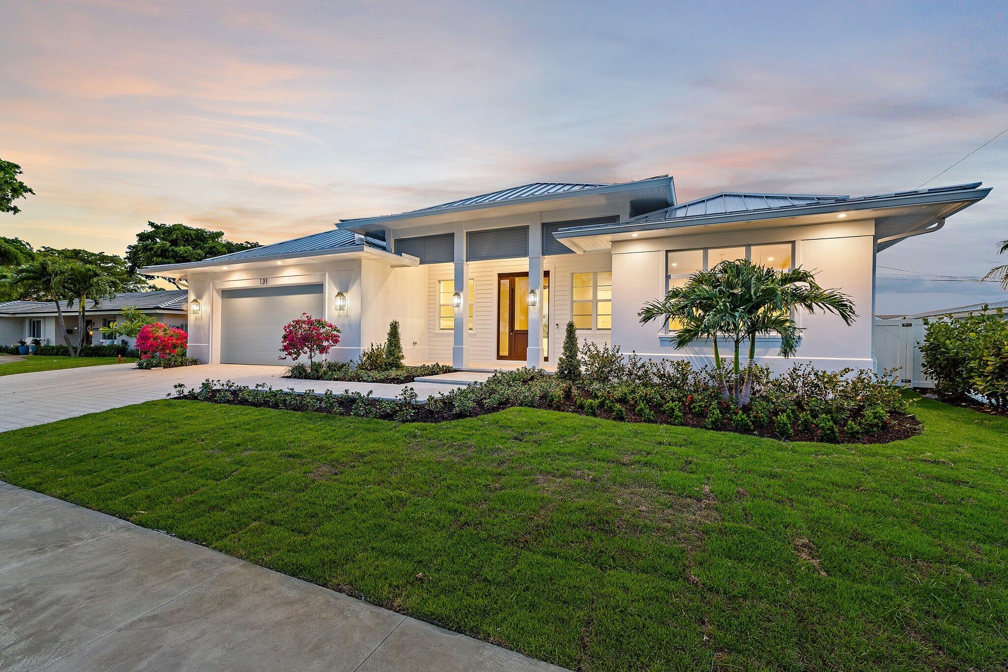 The Contemporary Coastal Village lifestyle awaits in this stunning brand-new 2026 construction, one-story, four-bedroom, four-bathroom pool home, mere moments from Lakeside Park in the heart of North Palm Beach! Beyond the stately foyer, natural light pours through this perfectly appointed open-concept residence, finished with white oak flooring and designed with no detail overlooked. Entertain in the great room featuring a vaulted ceiling with exposed beams, custom bar cabinetry, and seamless flow to the dining area overlooking the pool and lushly landscaped backyard. The stunning chef's kitchen showcases a custom-crafted range hood, beautiful white custom cabinetry with glass display panels and under-cabinet lighting, Quartz countertops, a timeless tile backsplash, pot filler, custom cabinet-front double refrigerator/freezers, and stainless-steel Thermador appliances, including a gas range, glass-front wine cooler, and island-mounted power drawer microwave. The center island offers bar seating and abundant under-counter storage. Retreat to the spacious primary suite featuring a custom walk-in closet and a tranquil spa-inspired primary bath with dual vanities, an expansive walk-in shower with bespoke tile and rain shower head, and a Roman tub. Two additional spacious bedrooms, situated across the split floor plan, feature en-suite bathrooms with custom marble vanities, frameless glass showers with uniquely curated tile finishes, and walk-in closets. Located just off the foyer, the fourth bedroom features an adjacent full bathroom with a marble vanity, frameless glass shower, all finished in marble, making it equally suited as a home office or den. The spacious laundry room, complete with raised washer and dryer platforms and abundant storage cabinetry, is finished with striking tile and leads to a custom built-in drop zone. Relax on the covered North-facing patio beneath pecky cypress and tongue-and-groove ceilings, complete with an outdoor kitchen overlooking the saltwater pool with swim shelf, heater, and chiller, and raised spa with spillover. The paver driveway leads to a spacious two-car garage plus dedicated golf cart storage, featuring epoxy floors and LED lighting. Additional upgrades include an indoor/outdoor sound system, custom closets, designer lighting and hardware, and much more. Enjoy all that desirable, membership-optional North Palm Beach has to offer : new clubhouse, restaurants and bar, redesigned Jack Nicklaus Signature golf, driving range, tennis center, Olympic-sized swimming pool with splash play area, private boat ramp, marina, playgrounds, parks, organized activities, all minutes from the area's best education, dining, shopping, and Palm Beach International Airport!