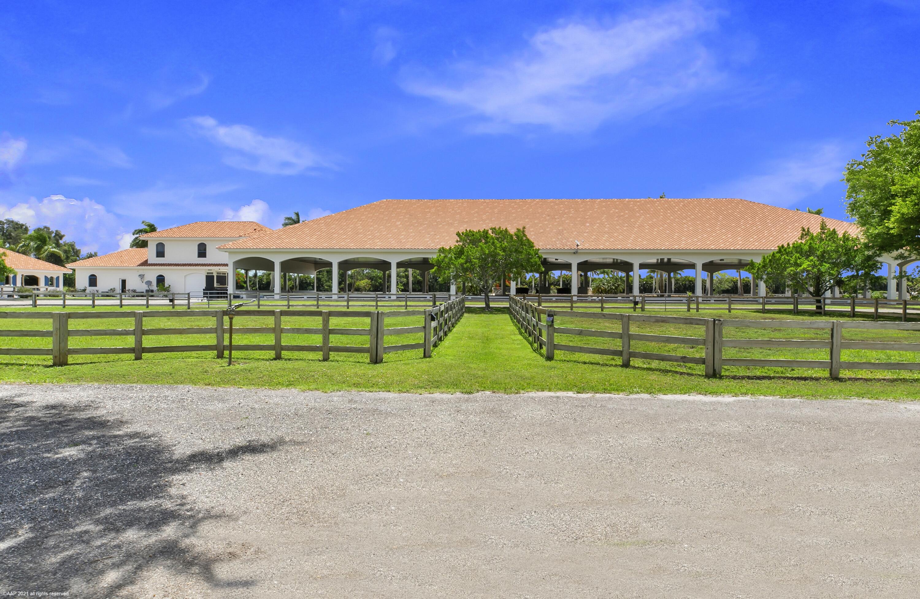 Private 20 Acre horse farm with 37 Stalls! This beautiful farm functions across all disciplines with 3 separate stables, 2 outdoor jumping arenas, covered riding arena with mirrors with viewing pavilion, 22 grass paddocks, 2 studio apartments, one 1Br/1Bth apartment & 3Br/1Bath owner's apartment, all peacefully nestled up against the everglades with an end of street location! The property also boasts: owner's lounge, air-conditioned feed rooms, 6 horse euro-walker, stallion paddocks, round pen, 3 RO systems, 80 KW Kohler diesel generator and 3 RV hookups. The back 5 acres is all pastureland with four 12' x 24' run-in sheds & 4 stall ctr-aisle pole barn with water & electric, all of which are bonus stalls in addition to the 37 stalls in the show barns!