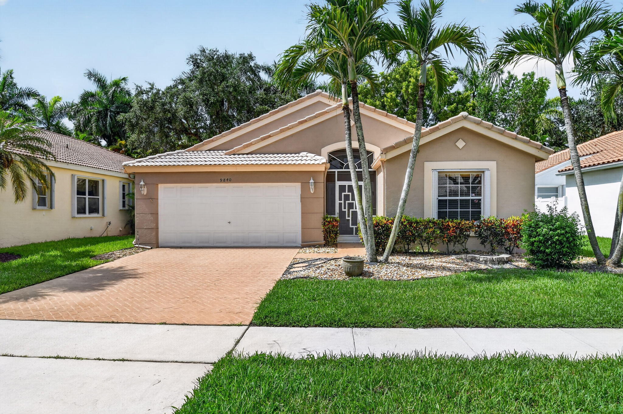 Welcome to this well-maintained 3-bedroom, 2-bath home with a 2-car garage, located in the highly sought-after Palm Isles West community. This home offers a wonderful opportunity to move right in or personalize it over time to match your vision! The thoughtfully designed floor plan features spacious living areas, flawless tile flooring throughout, and an oversized covered and screened patio which is perfect for enjoying Florida's beautiful weather, entertaining friends, or simply relaxing with your morning coffee. Recent updates include a new A/C, new water heater, and a brand-new refrigerator, providing valuable peace of mind while leaving plenty of opportunity to add your own personal touches!  Palm Isles West is known for its exceptional active adult lifestyle and recently completed state-of-the-art clubhouse featuring resort-style amenities, cafe, multiple swimming pools, pickleball and tennis courts, fitness facilities, card rooms, social clubs, entertainment, and countless activities. Conveniently located near shopping, dining, beaches, and major highways, this is your chance to enjoy one of Boynton Beach's premier 55+ communities. Whether you're looking for a full-time residence or a seasonal retreat, this home offers solid value, an excellent layout, and the opportunity to make it truly your own! Welcome Home!