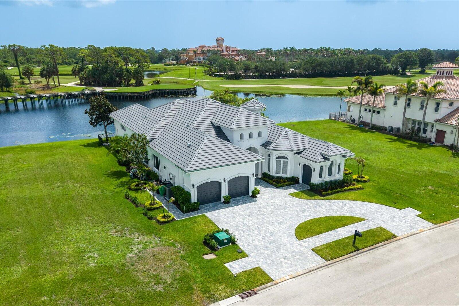 With views of Tesoro's club & holes 10 & 18 of the Palmer G.C., this lakefront renovated Modern Med. 4 BR, 4.5 Bath home is now available. Blending the look & feel of new construction with the exception design of true craftsmanship, having 16 ft high ceilings, New flooring, New LED lighting & fixtures, 2 electric fireplaces, all secured by storm-proof windows & doors, along with an emergency generator. The family chef will love the enlarged kitchen, featuring a breakfast bar, new cabinetry, a new Forno double frig/freezer, and a new 8-burner natural gas range. The primary features a vestibule entry with a morning bar, double closets with custom cabinets, 14 ft. High tray ceiling and fully renovated bath with new tub, shower, & cabinets with quartz countertops. Club membership is optional.  This rare Tesoro residence defines single-story elegance, offering nearly 4,000 square feet of beautifully reimagined living space with four bedrooms, four and half bathrooms, a two-car garage, and a separate golf cart garage. Every detail of this home has been lovingly reimagined with the precision and design sensibility of today's model homes—creating the perfect blend of classic Tuscan architecture and sleek, modern sophistication. Step through the mahogany double doors into a bright, well-lit foyer and great room with 16-foot-high soaring ceilings, new LED lighting, and an electric fireplace flanked by custom shelving. This architectural detailing is sure to impress the most discerning buyer. The expansive space opens seamlessly to the pool, lakefront, and golf course beyond, setting a tranquil, resort-like tone.  Inside, no surface was left untouched—new flooring, lighting, trim, and paint pair with an all-new gourmet kitchen and five completely redesigned bathrooms, each finished with high-end materials and designer fixtures. The result is a home that feels fresh, elegant, and move-in ready at a truly exceptional level. The exterior has been equally transformed. The façade's handcrafted stonework and Mediterranean character remain, but now gleam with crisp white paint, a brand-new concrete-tile roof, and all-new landscaping for a refined first impression. A new circle paver driveway in modern gray and white tones leads to the 2 garages, each finished with professional-grade epoxy floors that are both stunning and durable. Out back, your private pool awaits, surrounded by new pavers and a resurfaced pool and spa with upgraded equipment, creating a luxurious outdoor space perfect for entertaining or simply relaxing amid serene water and golf course views. From the covered patio, enjoy the sound of Great Herons nesting in the pines near the 10th tees. This home is your fortress of solitude, constructed of solid concrete block with poured-tie beams, and outfitted with impact-rated windows and doors, a new roof, and a whole-house Generac generator; it's ready for any Florida weather. This home is more than a residence—it's a statement of craftsmanship, comfort, and timeless design in one of Florida's most prestigious communities. Tesoro is a private, gated golf community, and club .Club membership is optional for this residence.