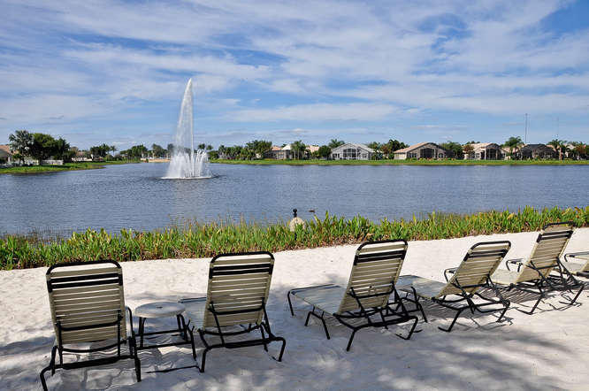 WATER WATER EVERYWHERE! Amazing Southern center Lake views will wow you the moment you open the front door! Beautiful incoming sunlight combined with the best water views create immediate peace & serenity! All white glossy cabinetry, beautiful granite, neutral newer tile floors, newer Light cream berber in bedrms , newer washer/dryer, newer LED lighting throughout, Jacuzzi spa tub in owners suite, so much more, are just a few of the extras in this fabulous home!  French doors leading out to the huge extended screened lanai & lake are charming, Owners suite has its own French door to the lanai & lake also! This 3 bedrm, 2.5 bth Caribbean 111 floorpan truly has some of the most charming architecture of all  floorplans. Newer accordion shutters (2018) provide hurricane readiness! LOVE IT!!!!! SUPER HIGH CEILINGS! HOA monthly fee includes cable TV, hi speed internet, wi-fi, in home monitored security system, outside painting of the home, roof cleaning, lawn and shrub maintenance, $400 Bistro credit every year, 10 Tennis, 6 pickleball, bocce crts! 2 Indoor racquetball crts, indoor whirlpool, suana, steam, beauty salon, state of art fitness center, resistance pool, hot tub, lap pool, tennis/pickleball pro shop, massage room, full time social director, water aerobics, club, organizations, cards, mah Jong, poker, billiards and so much more! Valencia Shores is one of the most fun and upcoming 55 plus very active communities! Live your best life! LOVE THIS HOUSE! MORE PHOTOS COMING!