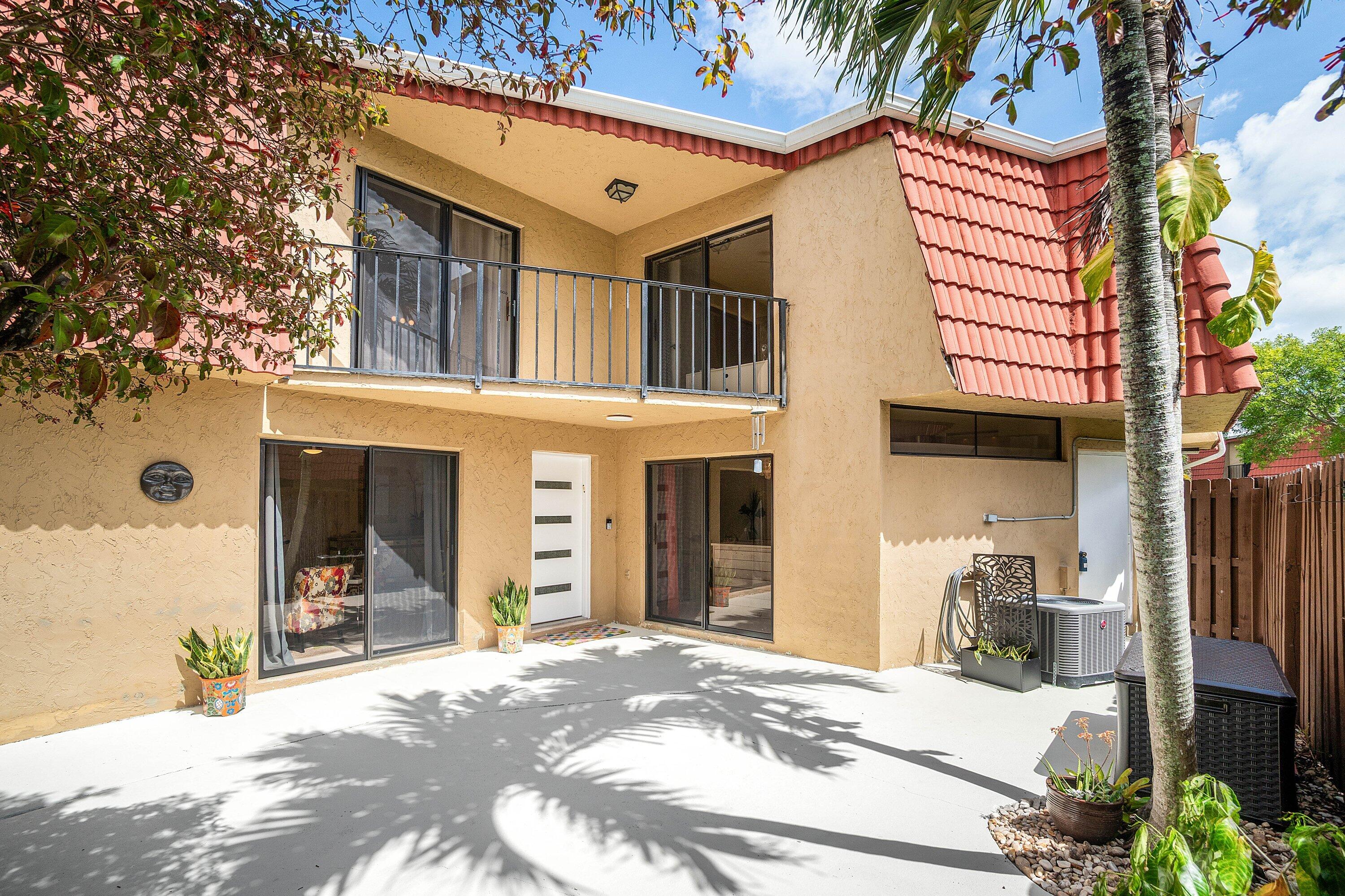 Welcome to this beautifully updated two-story courtyard townhouse in the heart of Boca Raton, located in the sought-after Boca Rio North community. Bright and spacious, this 2 bedroom, 2.5 bath residence offers modern upgrades throughout, an open floor plan, and a private fenced courtyard perfect for quiet morning coffee, relaxing outdoors, or easy entertaining. The contemporary kitchen features quartz countertops, a tile backsplash, and generous cabinet and counter space, flowing seamlessly into the living and dining areas for today's lifestyle. Brand-new exterior window and slider screens run throughout. Completing the first floor are a convenient half bath, full-size washer and dryer, additional storage, and the ease of first-floor entry.  Upstairs, two generous ensuite bedrooms each offer a private bath and ample closet space, providing comfort and privacy. Both bedrooms open through sliders onto a shared balcony with serene garden views.  Community amenities include a clubhouse, pool, tennis courts, and scenic walking paths. Boca Rio North is pet-friendly, welcoming two dogs, and rentals are permitted after two years of ownership.  Ideally located near dining, shopping, everyday conveniences, and major roadways, this home also offers access to all that Boca Raton has to offer, including world-class beaches, Spanish River Park, South Inlet Park, Red Reef Park, Town Center, Mizner Park, and the Boca Raton Museum of Art.  Thoughtfully priced and offering a refined blend of relaxed Florida living, comfort, and convenience, this townhouse is a wonderful opportunity to own in a prime Boca Raton location.