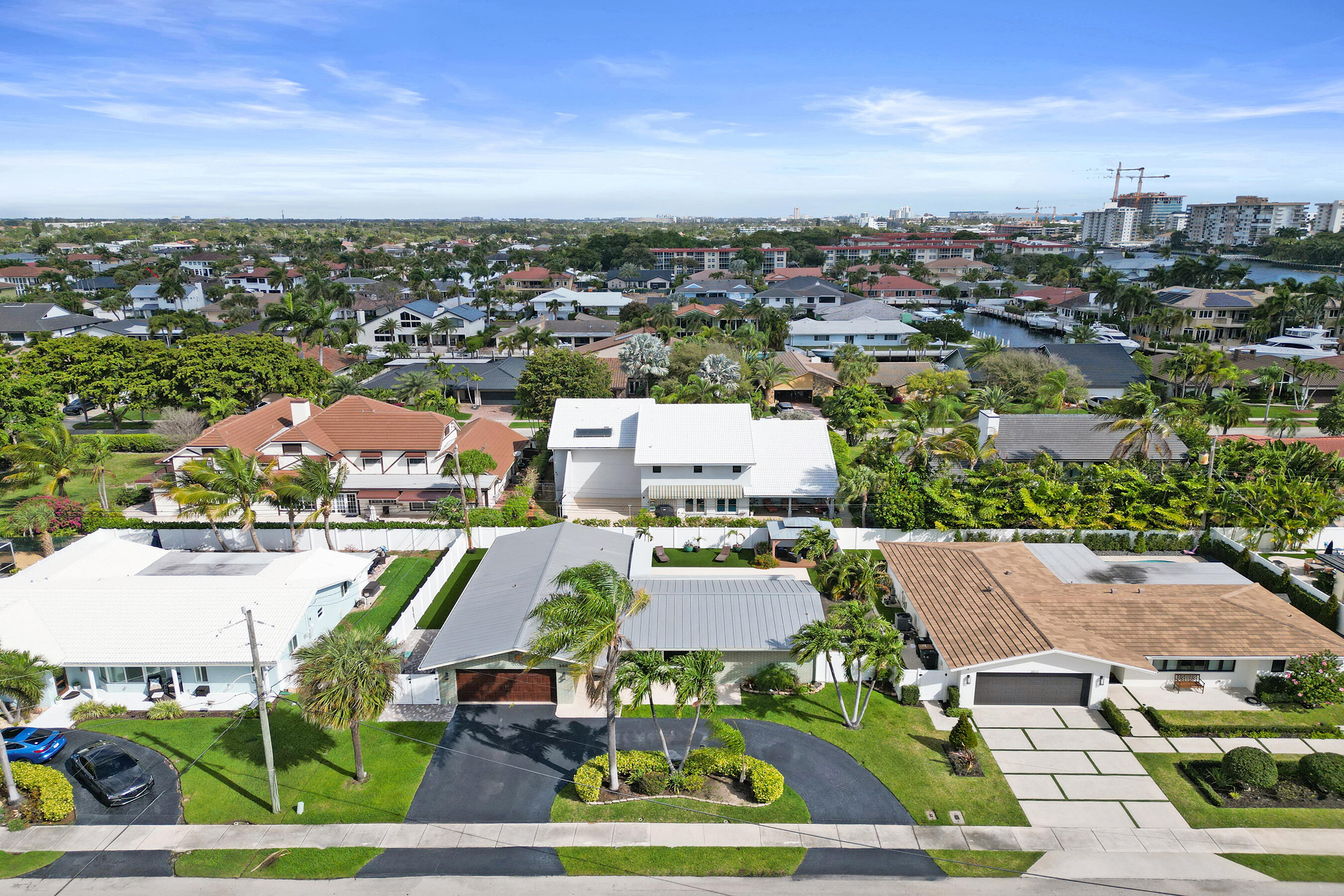 Nestled on a quiet street across from multi-million-dollar homes and just moments from the Intracoastal estates of Lighthouse Point, this Ruttenberg-style home offers 4 bedrooms, 3 baths, and a split-bedroom layout with an additional room ideal for a home office. Spacious living areas, a formal dining room, and abundant natural light create a welcoming atmosphere and flow seamlessly to outdoor spaces perfect for entertaining. Recent upgrades include PVC plumbing (2019), A/C and refrigerator (2022), awning, bath remodel and disposal (2023), and 2024 improvements including artificial turf, backyard pavers, fence, saltwater pool pump and filter, and hot water heater. Additional features include all impact doors and windows, updated electrical panel, and app-based home automation.
