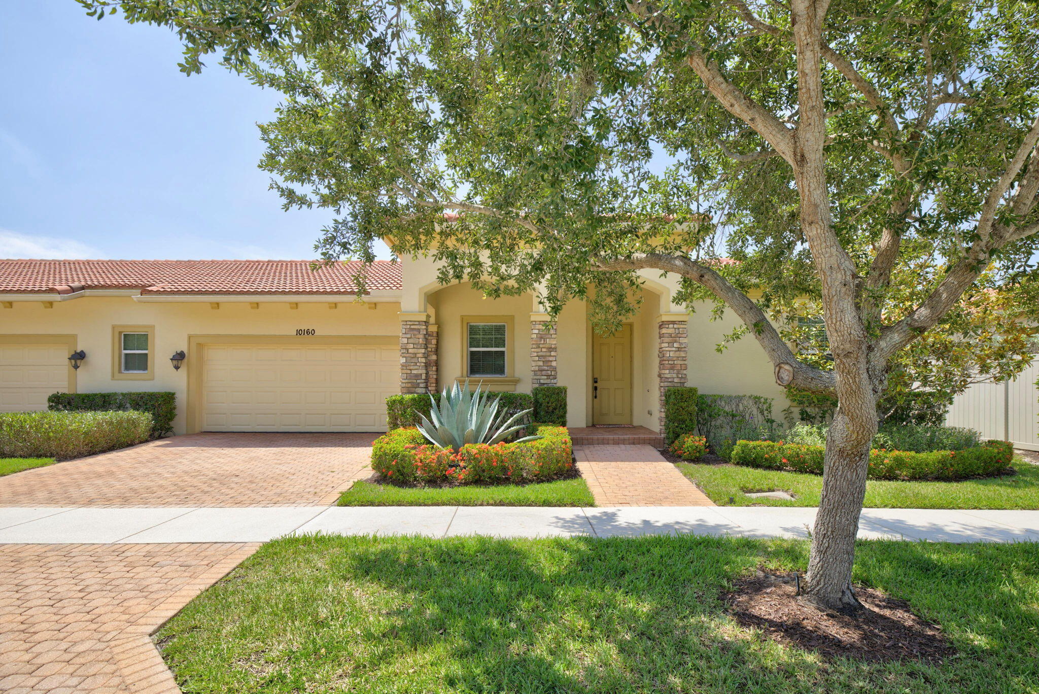 Welcome to 10160 SW Azzo Lane, a beautifully maintained end-unit villa located in the highly sought-after PGA Verano community in Port Saint Lucie. Built in 2013, this 2-bedroom, 2-bath residence offers 1,412 sq ft of thoughtfully designed living space with a desirable split-bedroom layout. The open-concept floor plan features a spacious great room with a coffered ceiling and freshly painted interior. The kitchen is appointed with granite countertops, espresso-tone cabinetry, stainless steel appliances, and ample storage. Tile flooring laid on the diagonal enhances the main living areas, while the private bedroom layout provides comfort and privacy. Additional highlights include a garage bump-out, ideal for a golf cart or extra storage, a covered front patio, and a screened rear patio surrounded by lush landscaping perfect for relaxing or entertaining.  Residents enjoy guard-gated security and access to resort-style amenities, including Club Talavera, a 40,000-sq-ft clubhouse with fitness center, indoor and outdoor pools, spa, tennis, pickleball, bocce, and an active social calendar.  An exceptional opportunity for full-time living or a seasonal retreat in one of Port Saint Lucie's premier communities.