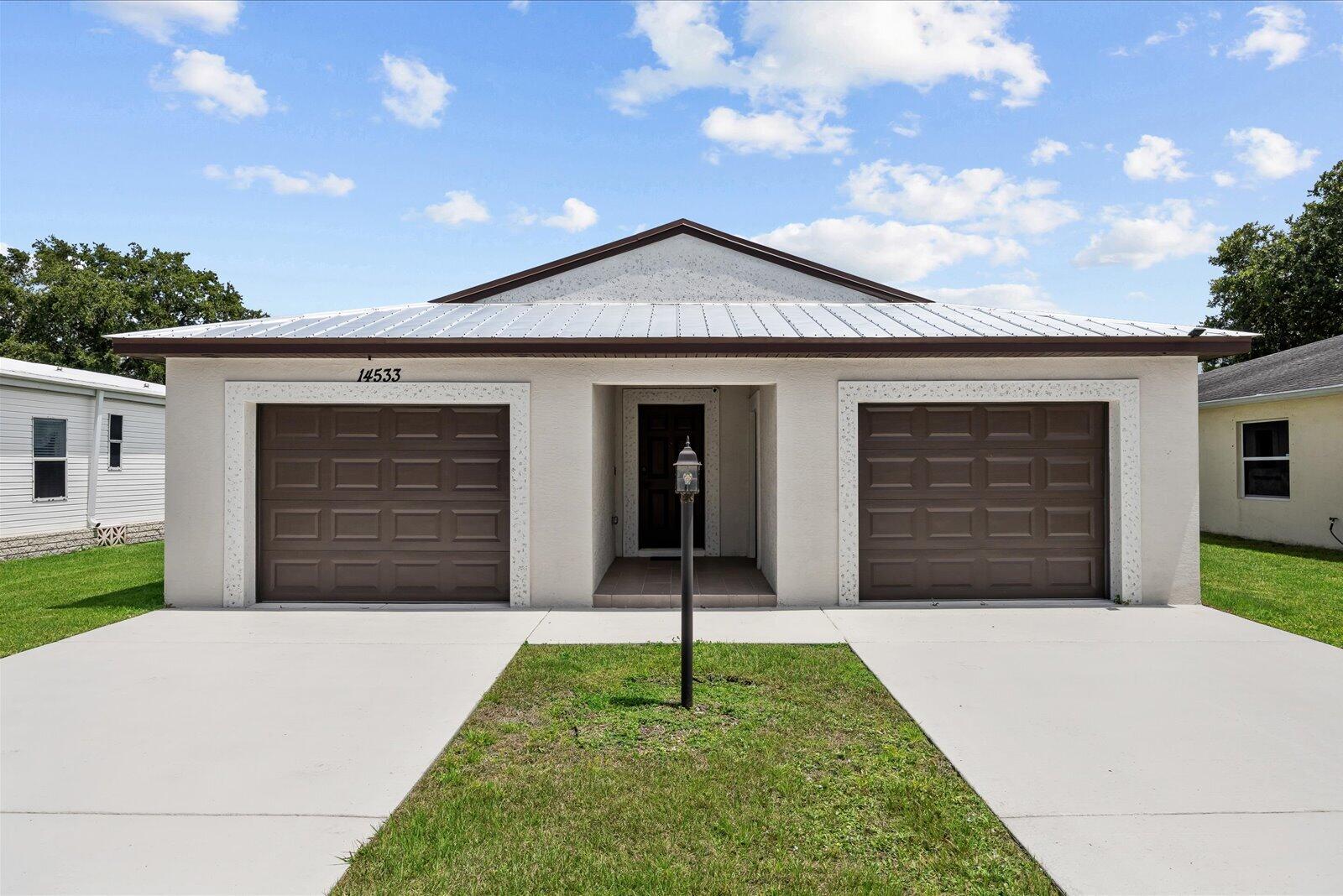 ATTENTION BUYERS!!! NEXT BUYER WILL GET $550 LOCKED IN LIFETIME RENT ON THIS RESALE HOME. IT WILL NOT INCREASE AS LONG AS YOU OWN IT!! Built in 2023 and barely lived in, this stunning CBS home is immaculate and loaded with upgrades throughout. Featuring 3 bedrooms, 2 bathrooms, impact windows, a durable metal roof, and R-30 insulation, this home offers both comfort and peace of mind. Step inside to an open floor plan with vaulted ceilings and upgraded laminate/vinyl plank flooring throughout the main living areas. The island kitchen is a showstopper with shaker cabinets, granite countertops, additional cabinetry, shaker cabinets, and space for a wine fridge — perfect for entertaining. The spacious primary suite features a coffered ceiling and custom barn door, creating a luxurious retreat. Enjoy relaxing evenings on the screened-in  patio with privacy blinds or cozy up by the electric fireplace.  Additional upgrades include: • Oversized driveway • One-car garage plus golf cart garage • Electric blinds on the sliding doors • Granite countertops in kitchen and bathrooms • Metal roof & impact windows • Barely lived in and move-in ready  Located in the highly desirable Spanish Lakes community, residents enjoy resort-style amenities including an 18-hole private golf course, clubhouse, swimming pools, tennis courts, pickleball, shuffleboard, billiards, fitness center, social clubs, community events, and more — all designed for active Florida living. This meticulously maintained home combines modern style, functionality, and an unbeatable opportunity with lifetime lot rent for the next owner!
