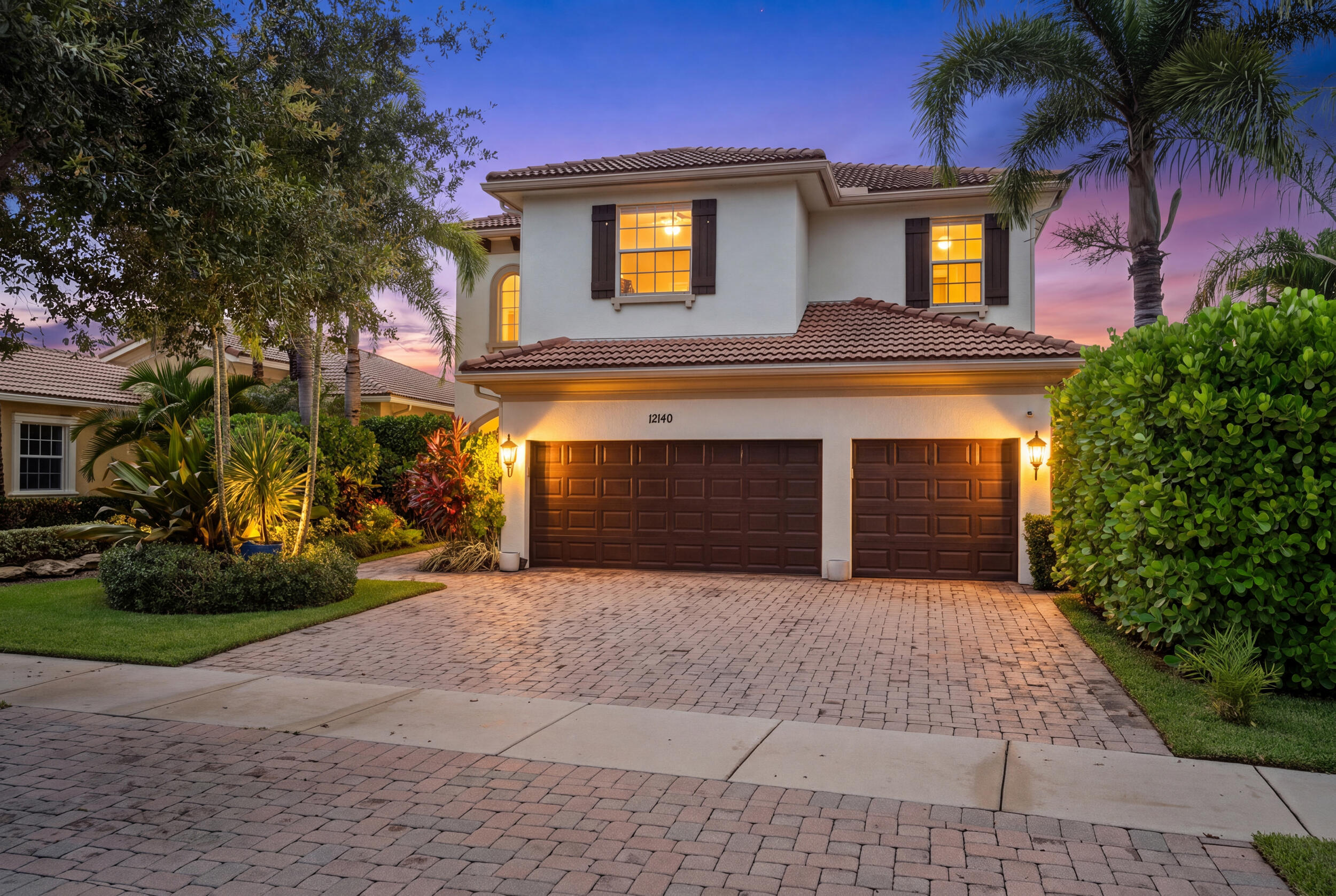 Welcome to the LARGEST model in Paloma! Perfectly positioned on a picturesque lake in the sought-after gated community of Paloma, this 5-bedroom, 4-bathroom, 3-car garage home offers the ideal combination of sophisticated design, peaceful water views, and an unbeatable Palm Beach Gardens location.  The thoughtfully designed floor plan offers one bedroom and full bath on the main level, while upstairs you'll find four additional bedrooms surrounding a spacious loft, providing the perfect flex space for a media room, playroom, or home office.  The heart of the home is the stunning chef's kitchen, featuring sleek handle-free cabinetry, quartz countertops, a large center island, GE Profile appliances, a built-in refrigerator, double ovens, cooktop with a vented hood, wine refrigerator, breakfast nook, and industrial-inspired designer lighting. Wide-plank wood-look tile flooring flows seamlessly throughout the main living areas, creating a warm, contemporary feel.  The backyard is nothing short of exceptional. Take in the expansive lake views while relaxing beside the heated pool and spa, prepare meals in the fully equipped summer kitchen, or gather around the outdoor fireplace beneath the covered lanai, which features a tongue-and-groove ceiling, oversized industrial fan, and retractable awning.  Practical luxury continues with an insulated, air-conditioned 3-car garage featuring a premium epoxy floor, overhead storage shelving, and dual electrical panels. Just inside, the custom mudroom offers abundant built-in storage and a convenient dog wash station.  Located in one of Palm Beach Gardens' most desirable gated communities, Paloma offers beautifully maintained grounds, resort-style amenities, and an unbeatable location just minutes from world-class shopping, dining, beaches, golf, and major highways. This is a rare opportunity to own a truly turnkey home where every detail has already been thoughtfully perfected.