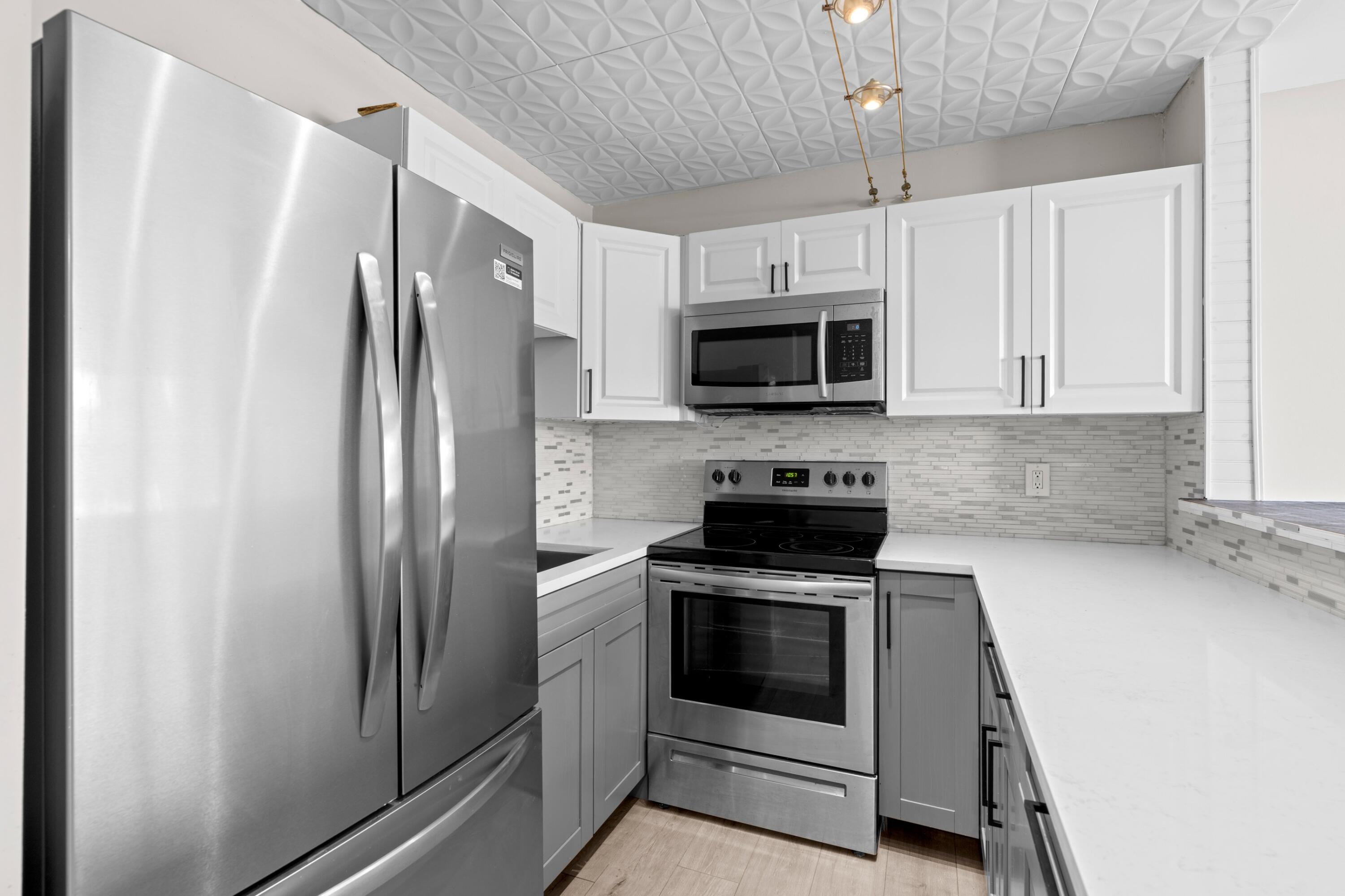 Rarely available and beautifully renovated from top to bottom, this stunning first-floor residence has been completely transformed with modern finishes throughout. Every detail has been thoughtfully updated, including brand-new flooring, sleek countertops, stylish cabinetry, new stainless steel appliances, a beautifully remodeled bathroom, fresh interior paint, and more - creating a truly move-in-ready home.  Enjoy seamless indoor-outdoor living with a covered and enclosed patio featuring low-maintenance turf flooring, offering the perfect space to relax while overlooking peaceful garden views. Located in the highly sought-after 55+ Camden section of Century Village, residents enjoy an unparalleled resort-style lifestyle with an impressive array of amenities, including a sparkling community pool, state-of-the-art fitness center, billiards room, library, clubhouse, and an exciting calendar filled with social events, clubs, and activities designed to keep you active year-round.  Whether you're looking for a full-time residence or the perfect seasonal retreat, this rare first-floor opportunity combines modern luxury, convenience, and one of the best active adult lifestyles in West Palm Beach. Just minutes from shopping, dining, beaches, highways, Palm Beach International Airport, and vibrant downtown West Palm Beach, this is South Florida living at its finest.