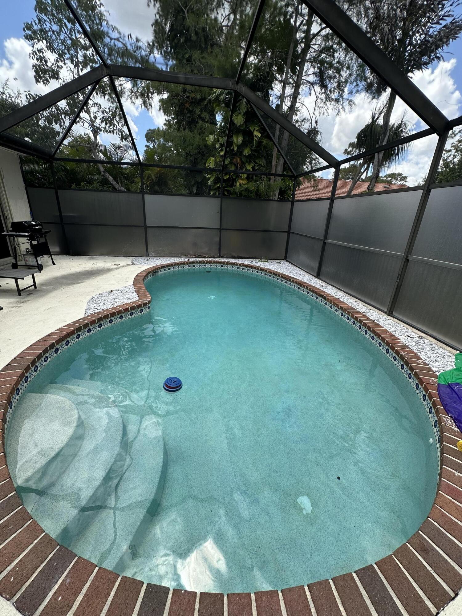 Welcome to this beautifully fully renovated 3-bedroom, 2-bathroom home in the heart of Wellington! Every detail has been updated with modern finishes and tile flooring throughout. This move-in-ready home comes fully furnished, making it perfect as a primary residence, vacation home, or investment property. Enjoy your own private backyard oasis featuring a heated swimming pool, ideal for relaxing or entertaining year-round. Located in a quiet and secluded neighborhood, this home is zoned for some of the highest-rated schools in Palm Beach County, including Binks Forest Elementary and Landings Middle School. Currently operating as a successful Airbnb with no rental restrictions, it offers outstanding income potential while also being the perfect home for a family.