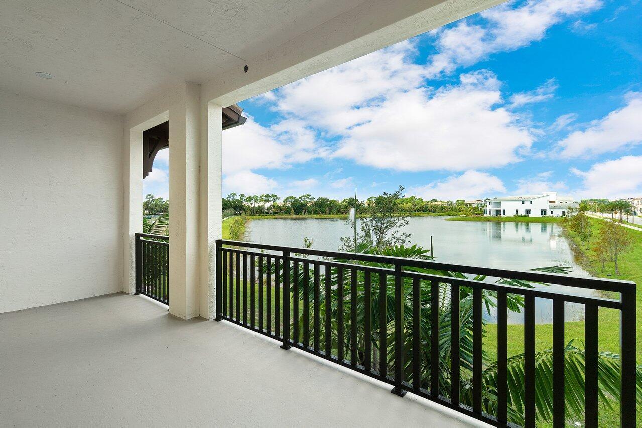 Welcome to this beautifully upgraded LAKEFRONT townhome in the highly sought-after Alton community of Palm Beach Gardens, where picturesque water views create a tranquil backdrop for everyday living. Offering 3 bedrooms plus a den, 3.5 bathrooms, and 2,252 square feet of thoughtfully designed living space, this exceptional residence seamlessly blends modern style, comfort, and convenience. The bright, open-concept main living area features upgraded wood-look luxury vinyl plank flooring and abundant natural light throughout. Designed for both entertaining and everyday living, the spacious living and dining areas flow effortlessly to a covered balcony overlooking the lake—an ideal setting for morning coffee, sunset views, or gathering with family and friends. At the heart of the home is a beautifully appointed kitchen featuring crisp white cabinetry, a large center island, designer backsplash, stainless steel appliances, and ample storage, creating a perfect blend of functionality and style. The third floor is dedicated to the home's private living quarters, including a spacious primary suite with two walk-in closets and a luxurious en-suite bathroom complete with dual vanities and a walk-in shower. Two additional bedrooms, a full bathroom, and a conveniently located laundry area complete the upper level. A versatile first-floor den with a full bathroom nearby provides the perfect space for a home office, gym, guest suite, or flex room. Residents of Alton enjoy an unmatched lifestyle with miles of scenic walking trails and resort-style amenities including a clubhouse, oversized community pool, tennis and basketball courts, playgrounds, dog parks, and expansive green spaces. Just moments away, Alton Town Center offers premier dining, shopping, fitness, and everyday conveniences—all easily accessible by golf cart. Ideally located near I-95, Florida's Turnpike, The Gardens Mall, world-class golf, pristine beaches, and Palm Beach International Airport, this exceptional lakefront residence offers the perfect combination of luxury, location, and lifestyle.