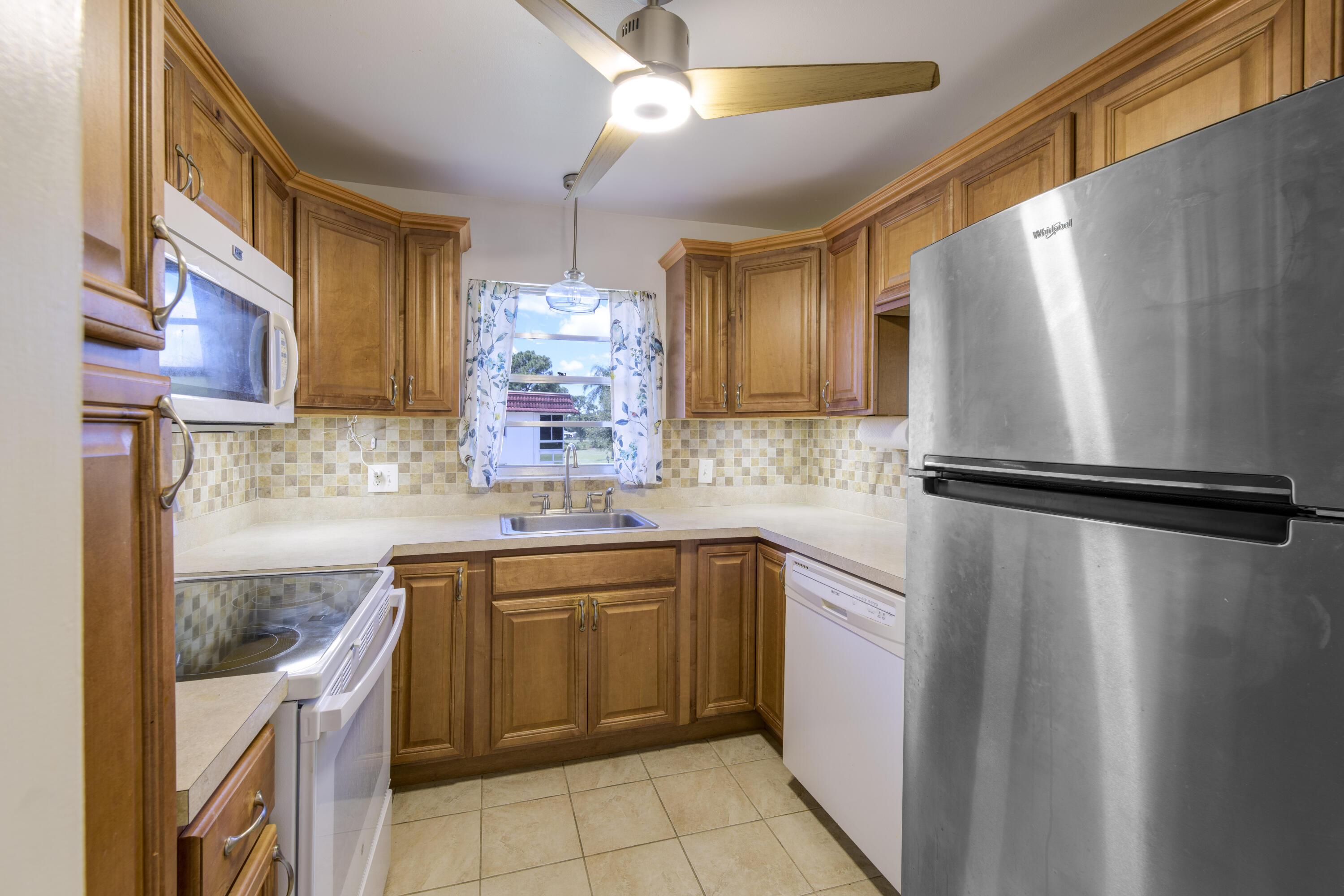 Beautiful 2nd-floor 2BR/2BA unit overlooking the 17th tee of the golf course. The home features a remodeled kitchen with maple cabinets and two Lazy Susan, along with updated cabinetry in both bathrooms. Enjoy laminate flooring throughout and the added protection of accordion shutters.  Conveniently located near the community laundry room at the end of the building. Located in Vita Del Lago, a vibrant 55+ community offering a clubhouse, pool, shuffleboard, and a wide range of social activities.  Enjoy peaceful, scenic views from the backyard. Close to restaurants, shopping malls, supermarkets, and just 10 minutes from Jensen Beach.  Must own for 2 years prior to renting.