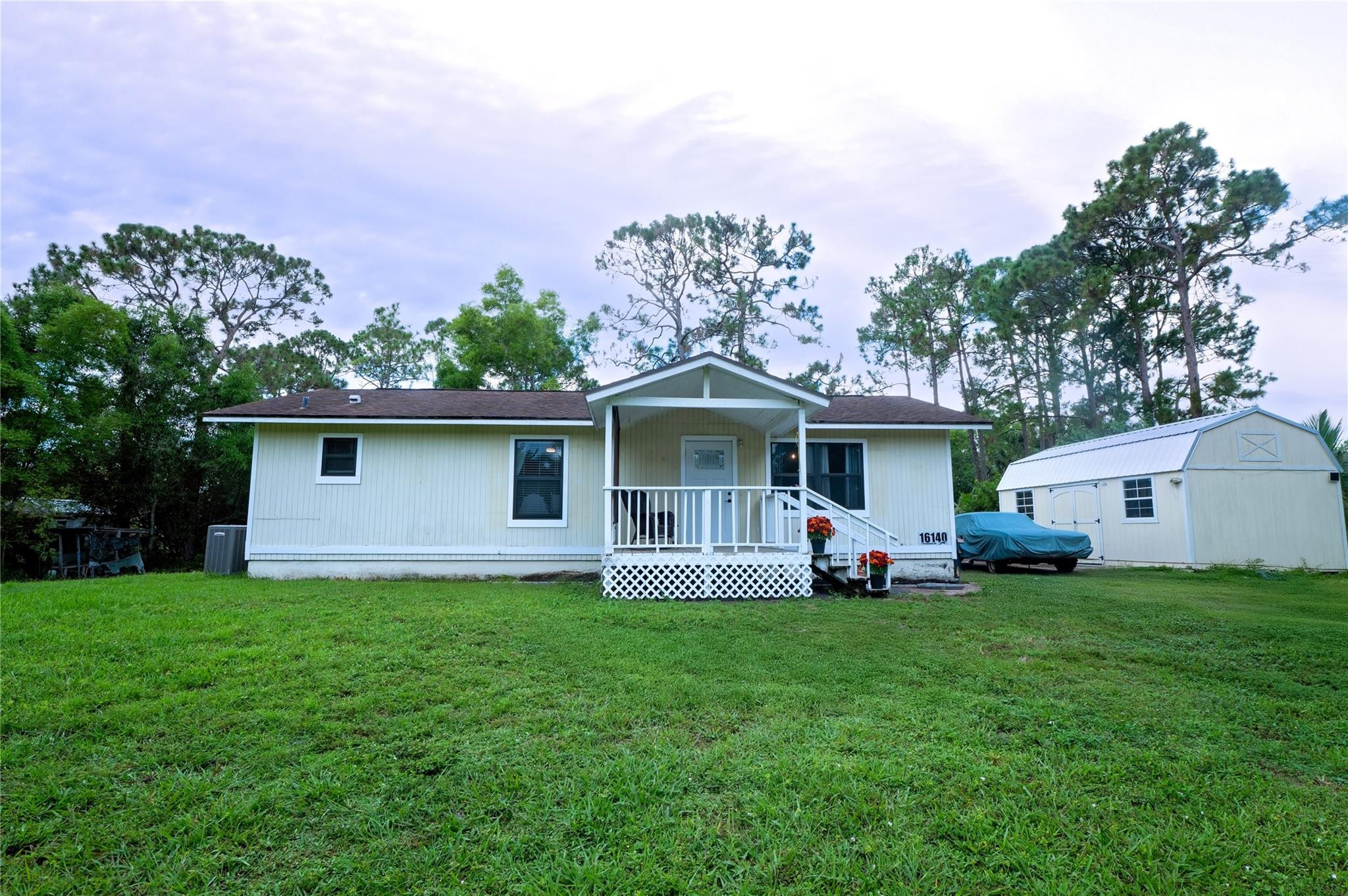 Welcome to your own private homestead oasis on 1.33 acres!  This updated & charming 2/2 home blends comfort with sustainable living. Enjoy hurricane impact windows & doors, a newer A/C, new tankless water heater and a Tesla panel. The open layout provides comfortable living space, while the yard offers endless possibilities for gardening, expansion, or simply enjoying the peaceful surroundings. Tucked away in a serene, natural setting, enjoy raising chickens in a custom coop, quails in a separate enclosure, fish in the pond & harvest fruit from the many fruit trees. ! A large 12x24 hurricane-rated shed adds storage, & there’s plenty of space for RVs, boats, or expansion—no HOA—Property is at the end of the street for ultimate privacy. This property offers it all! Your rural retreat awaits!