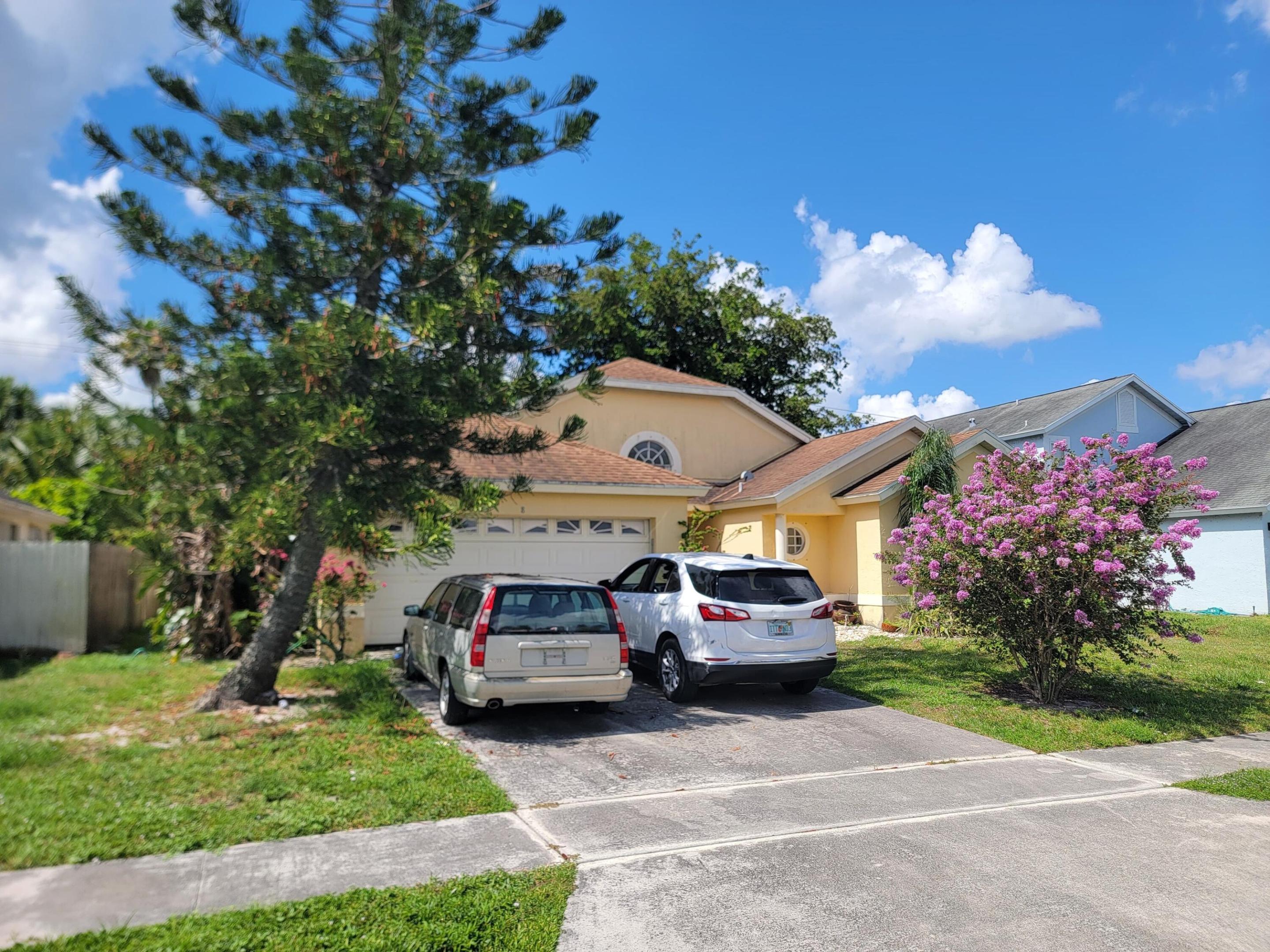 Perfectly situated in the heart of Boynton Beach, this beautiful 3-bedroom home offers the ideal combination of comfort, style, and privacy. A lush, tropical-inspired backyard creates a peaceful retreat, perfect for relaxing or entertaining. Inside, you'll be welcomed by soaring vaulted ceilings, elegant Palladian windows, and a bright, spacious floor plan. The main living areas feature tile flooring, while the bedrooms are finished with durable laminate flooring. The open-concept kitchen boasts quartz countertops, stainless steel appliances, a convenient snack bar, and a sunny breakfast area. Step outside to the covered, screened patio overlooking the private tropical backyard, providing the perfect setting to enjoy Florida living in a tranquil and serene environment.