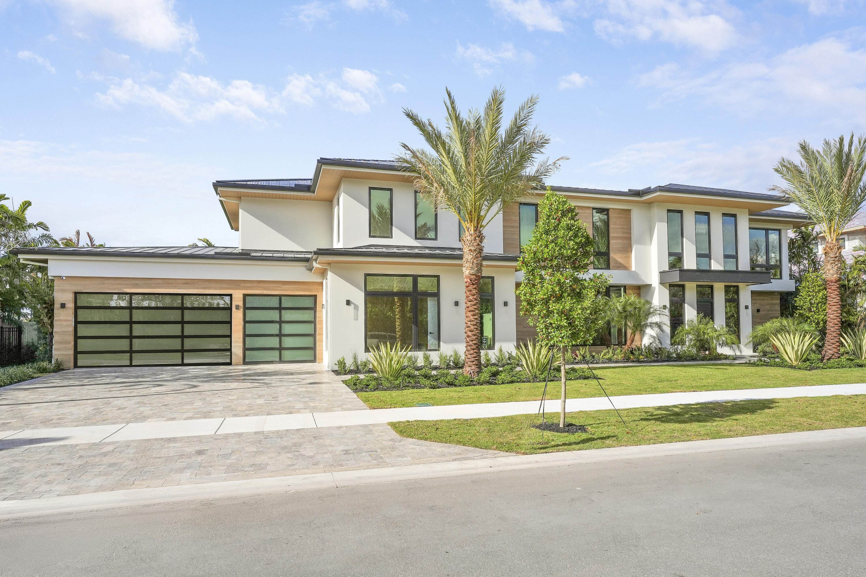 Welcome to Farrell Estates, a premier 27-home enclave in the Palm Beach Polo Club. Lot 22 commands attention with over 7,700 living sq. ft. and 10,000 total sq. ft. of architectural excellence. A grand staircase and two-story foyer lead to a main level finished in grand porcelain tile, featuring an open-concept family room, side bar, and chef's kitchen. This level includes a Junior suite and a unique flex-wing with a separate entrance, perfect for a gym or office. Upstairs, warm oak floors flow through five ensuite bedrooms and an expansive room. The primary sanctuary offers a private sitting room and spa-like bath. Outside, a 1,000+ sq. ft. patio with a pool and spa defines Hamptons-style luxury. Experience a residence designed for the most discerning buyer! The immense scale of Lot 22 is matched by its meticulous detail. The 10,000+ total square footage includes a massive 1,000+ sq. ft. second-story terrace, offering a breathtaking venue for evening cocktails. Inside, a personal elevator provides seamless access, while 2.25-inch solid core doors ensure ultimate privacy. Effortless estate management is guaranteed with dual laundry centers upstairs and downstairs each equipped with two washers and two dryers. Every finish is bespoke, from custom cabinetry to stunning quartzite countertops. The primary wing is a masterclass in luxury, featuring dual walk-in closets and a freestanding tub. Complete with a three-car garage for your collection, Lot 22 at Farrell Estates represents a curated lifestyle of sophistication and grandeur.