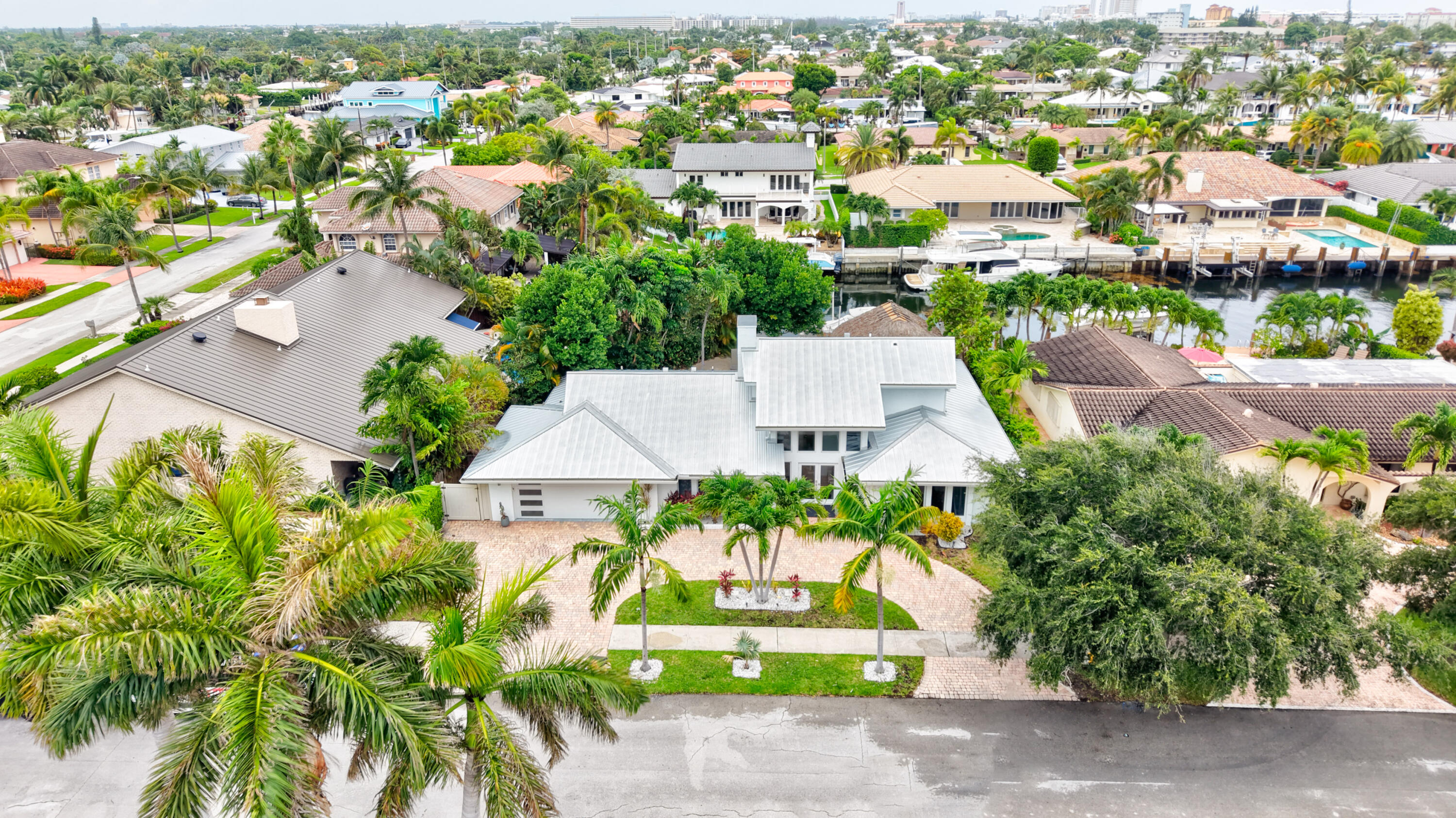 **Tropical Paradise in The Cove: The Ultimate Waterfront Lifestyle** Welcome to your dream waterfront oasis in the highly sought-after Cove neighborhood. This spectacular 4-bedroom, 3-bathroom pool home perfectly blends sophisticated indoor living with an unparalleled outdoor paradise. Designed for ultimate privacy and effortless entertaining, the backyard features a pristine pool wrapped in lush landscaping and a magnificent, custom tiki hut that brings resort-style living right to your doorstep. Whether hosting dynamic gatherings or enjoying quiet water views, this private sanctuary offers the absolute best of South Florida living.