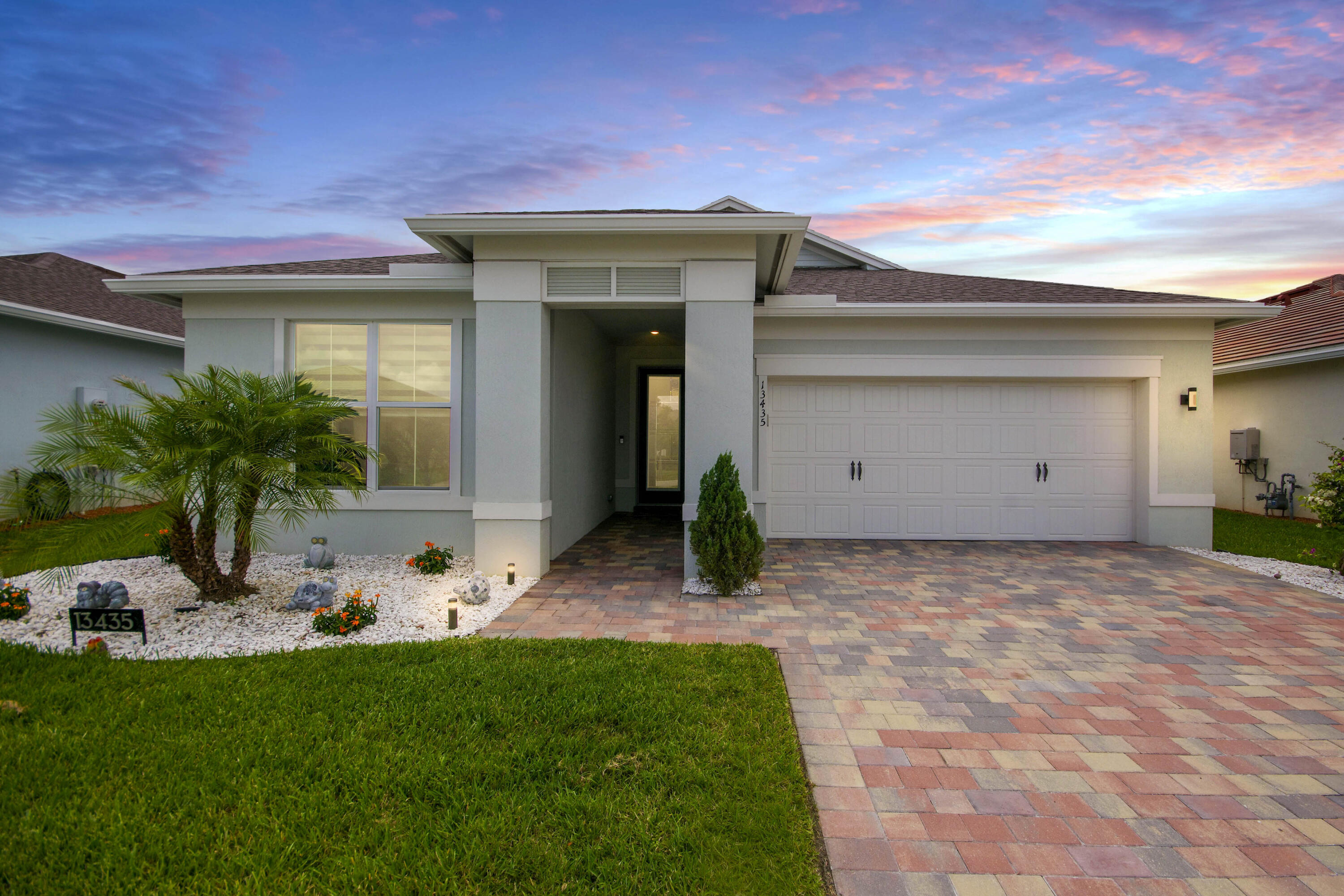 Fully remodeled and impeccably upgraded, this stunning home showcases top-of-the-line finishes throughout. Elegant 24" x 48" porcelain tile flooring flows seamlessly through the open Florida-style layout, creating a bright and sophisticated living space. The gourmet kitchen is designed for both beauty and functionality, featuring soft-close cabinetry with pull-out storage, a stylish glass tile backsplash, Samsung designer white glass appliances, and custom built-in pantry shelving. Enjoy enhanced comfort and convenience with electric zebra shades throughout the home, updated LED lighting, and designer fixtures and ceiling fans. Hurricane-impact windows and doors provide peace of mind, safety, and energy efficiency. The beautifully updated bathrooms feature floor-to-ceiling tile and modern  finishes that create a spa-like atmosphere. Step outside to the extended patio, finished with elegant gray travertine tile and overlooking lush, professionally landscaped grounds accented by landscape lighting—perfect for relaxing or entertaining year-round. This exceptional home combines luxury, style, and thoughtful upgrades in every detail. Del Webb community offers Resort Style Amenities: Two resort style heated pools, state of the art fitness center, dog park, Tennis, pickleball, and bocce ball courts, training kitchen, ballroom, Full-Time Lifestyle Director, locker rooms, movement studio, and two clubhouses. Schedule your private viewing today! All furniture and furnishings are negotiable.