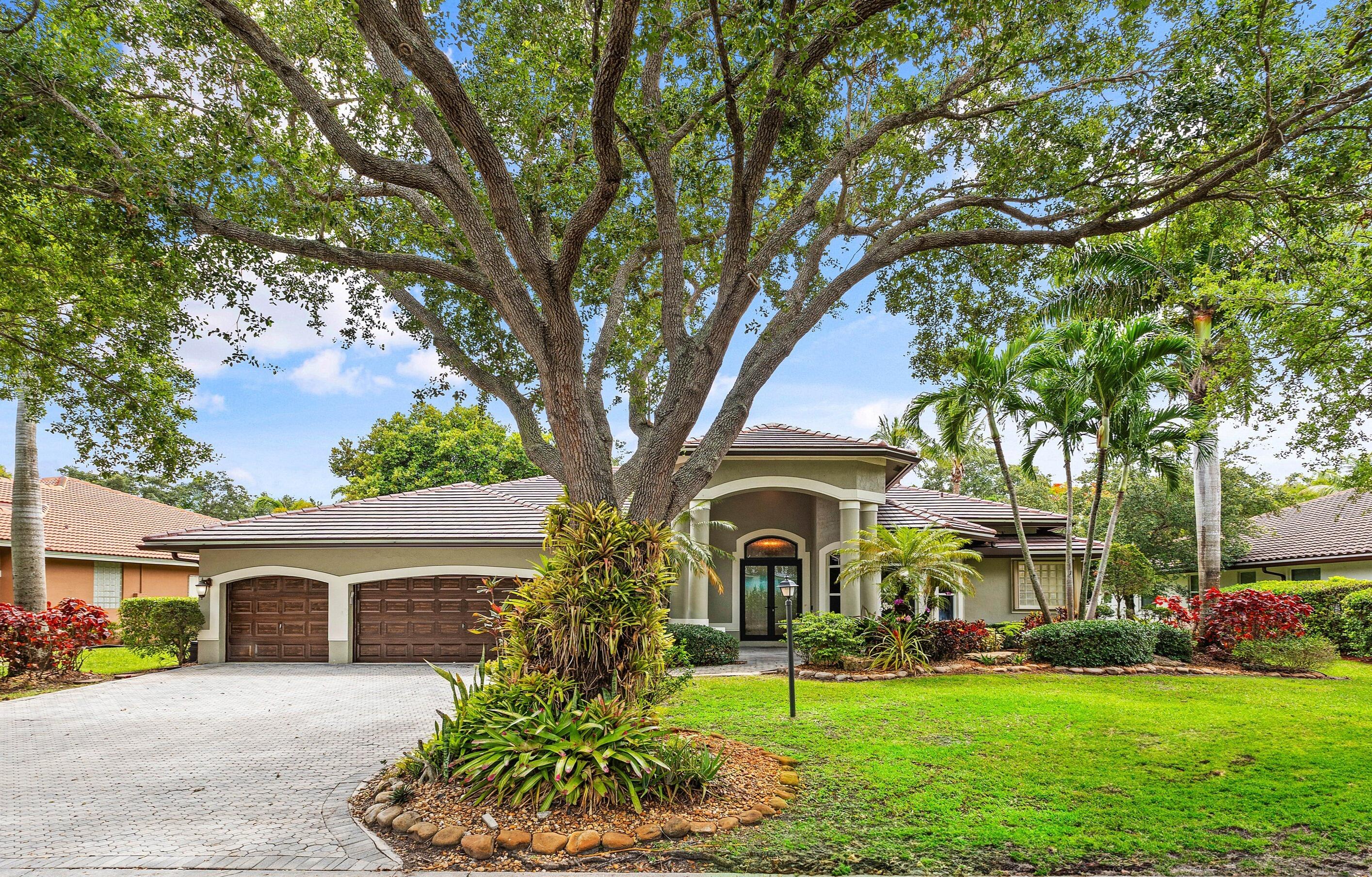 This beautiful home features a 2023 roof, lush landscaping, & a stunning glass double-door entry. Expansive windows & glass doors showcase resort-style views of the pool & tropical backyard throughout the home. The fabulous kitchen is a showpiece, featuring a  window backsplash, granite countertops, rich wood cabinetry, top-of-the-line appliances including an 8-burner gas range, & a wall of seamless butted glass that brings the outdoors in. Step outside to your private oasis with a heated saltwater pool & inviting outdoor living spaces. Other offerings: a new A/C, plantation shutters, some impact windows/doors, & newer pool heater & pump. Fox Ridge is one of Parkland's most sought-after communities. All assigned A+ rated schools are within walking distance