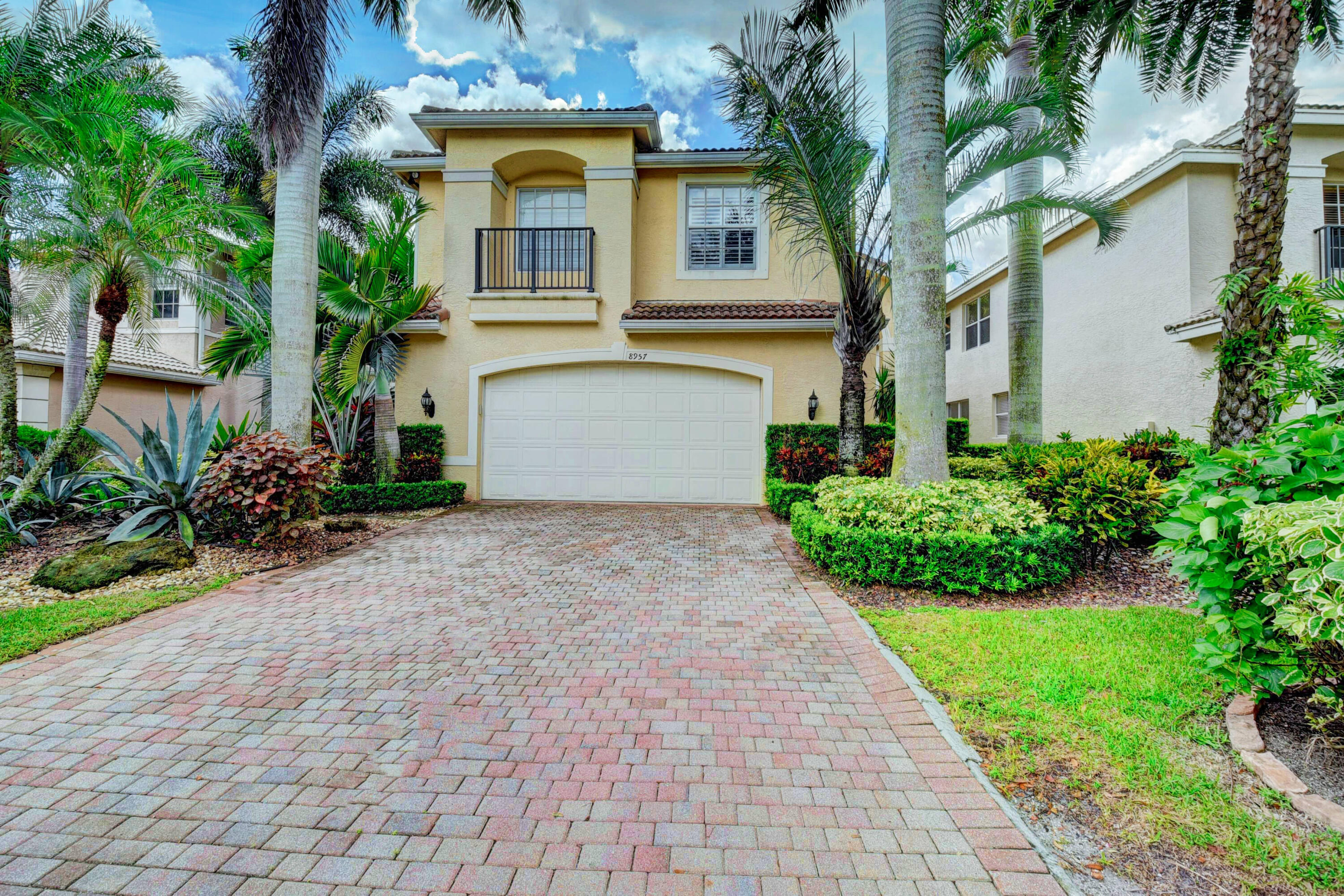 Welcome to 8957 Sandy Crest in Boynton Beach, a stunning residence that shows like a model home and offers the feel of a private tropical retreat. From the moment you arrive, the beautifully landscaped grounds create a resort-style setting that feels calm, elegant, and inviting.  Inside, the home is filled with upscale finishes and thoughtful upgrades, including 24-inch marble floors, vaulted ceilings, crown molding, plantation shutters, custom wall arches, recessed lighting, solid-core doors, central vacuum, and a built-in stereo/intercom system. The gourmet kitchen features GE Profile appliances, cherry cabinetry, granite countertops, and quality finishes throughout.  The bathrooms have been tastefully upgraded with premium vanities, and the primary suite offers a relaxing Jacuzzi-style  Additional features include top-of-the-line carpeting, premier garage storage cabinets, upgraded garage flooring, a newer A/C system, and many more details that add comfort, style, and value.  This beautifully maintained home is priced to sell and offers an exceptional opportunity in Boynton Beach.