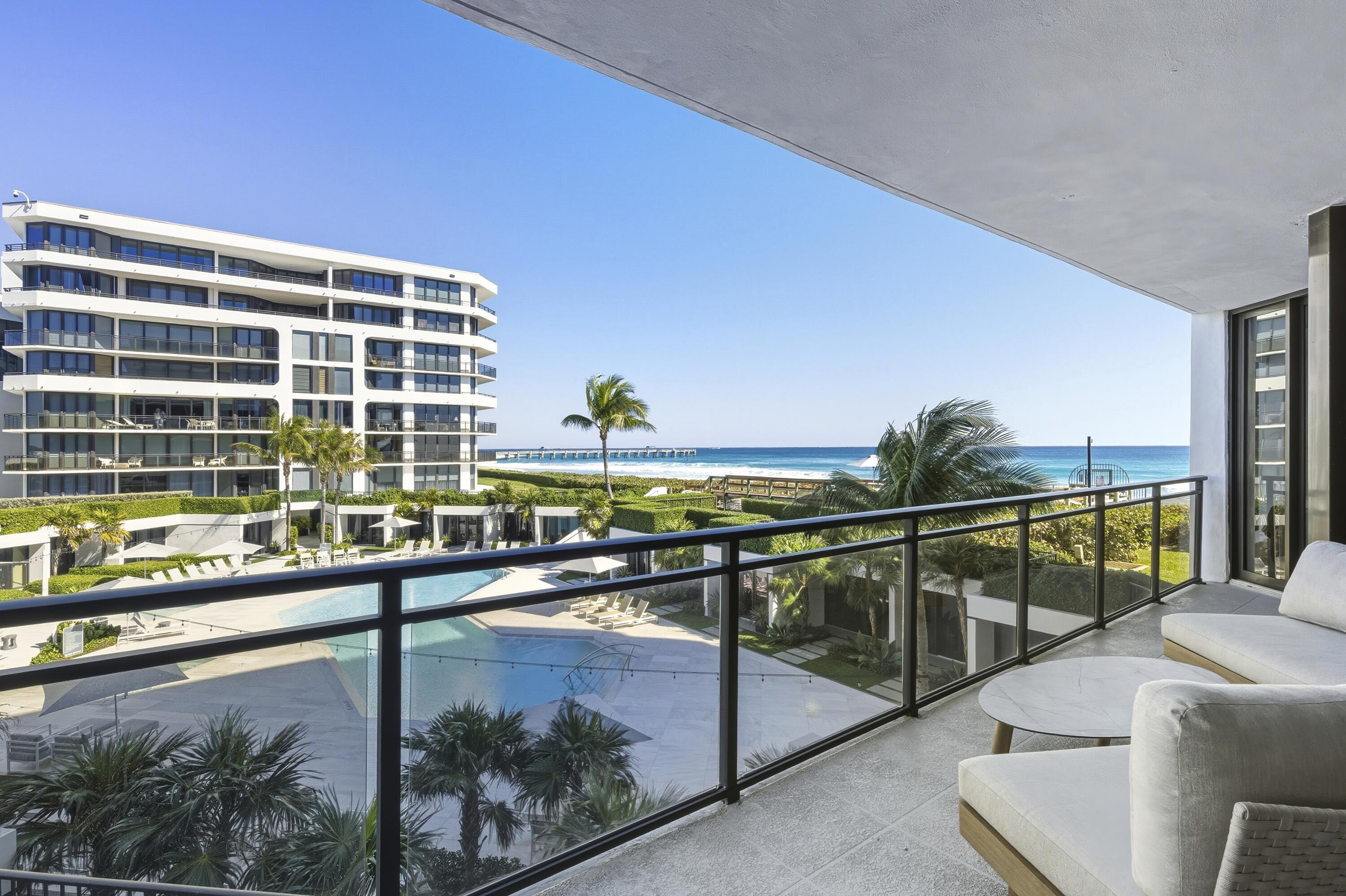 Enjoy refined coastal living in this immaculately renovated residence in the prestigious oceanfront Palm Beach Hampton. The expansive 2BR/2.5BA floor plan features a bright, open layout showcasing sweeping views of the Atlantic Ocean, resort-style pool, and Intracoastal Waterway. Interior upgrades include large format porcelain tile flooring, gourmet kitchen with custom cabinetry, high end luxurious bath fixtures & finishes, built-in custom closets, and motorized window shades. Two garage parking spaces included. Residents benefit from premier amenities including 24-hour staffed gatehouse and doorman service, a renovated fitness center, heated pool and spa, outdoor barbeque area, and tennis & pickle ball courts. Palm Beach luxury redefined with effortless oceanfront living!
