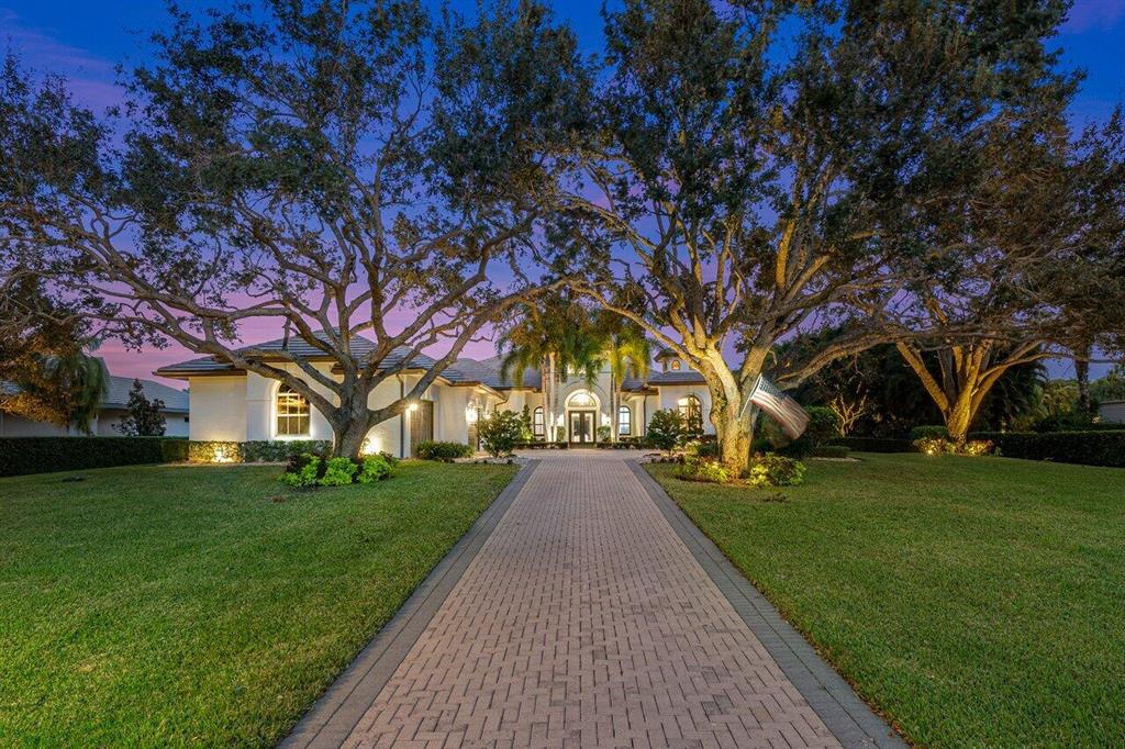 Stunning nearly 5,000 sq ft, 4 bedroom plus den/office, custom estate home situated on 1.03 acres in the exclusive gated community of Steeplechase. All guest suites offer ensuite bathrooms with potential 5th bedroom located in the guest bedroom wing. Light and bright gourmet kitchen featuring all Thermador appliances, spacious breakfast nook, oversized island, built in wine cooler, custom cabinetry, and more. Spacious primary suite with three walk-in closets, luxurious bath with large soaking tub, oversized shower, and separate dual vanities. This incredibly spacious home also offers a game room with wet bar and 1/2 bath with access to the gorgeous backyard, plus additional bonus room at the end of the guest wing that could easily be converted to 5th bedroom. The outdoor private oasis is the perfect space for entertaining with heated salt pool & spa with sun shelf, custom stone fire pit, putting green, large covered patio with wood planked ceiling and bar, built in grill, and so much more! Other features include complete impact glass, custom temperature controlled wine wall cellar, stunning architectural details throughout, marble flooring, and much more. Call for your private tour today!