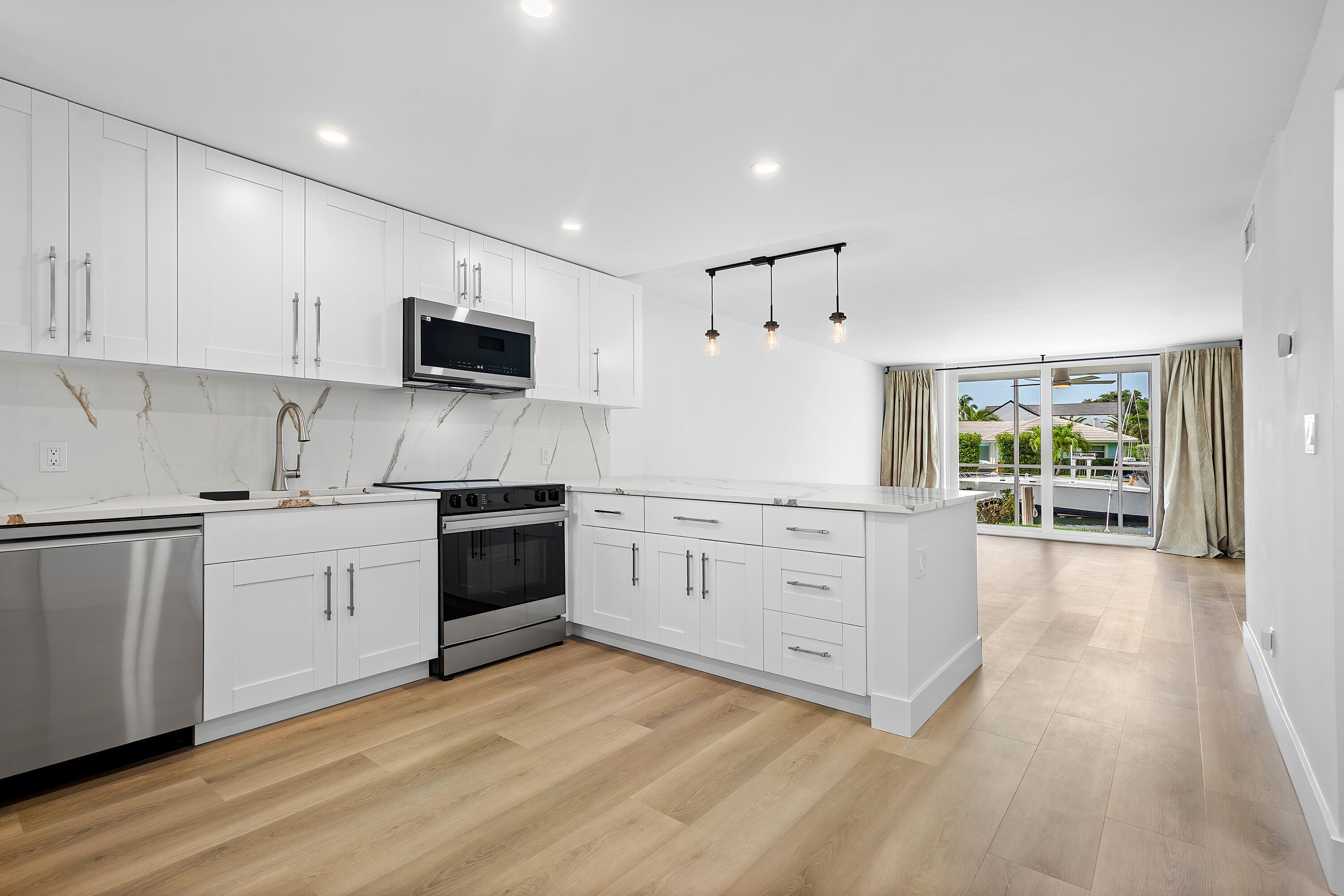 Welcome to Unit 109 at Boca House — a stunning, fully renovated water-front 2-bedroom, 2-bathroom ground-floor condo offering 1,056 sq ft of modern coastal charm. Every detail of this home has been thoughtfully updated. The brand-new kitchen features beautiful quartz countertops, soft-close cabinetry with ample storage, and brand new premium stainless steel Samsung appliances. The open concept provides the ideal space for entertaining and hosting family and friends... The combination of the natural light, fresh interior paint and recently installed vinyl flooring, give the unit has a light and bright feel throughout. A new electrical box was installed in 2025, and the unit is fully equipped with impact rated windows, sliders, and a brand new front door... Open your sliders to your screened in patio, where you can enjoy the peaceful views of the intracoastal.  The building features a private pool, easy access to the beach, and is minutes from the shops & restaurants of Mizner and Royal Palm Plaza. Boca House and unit 109 provides everything there is to love about the South Florida Coastal Lifestyle and is sure to leave a lasting impression! *BOAT SLIP LEASE AVAILABLE WITH PURCHASE"