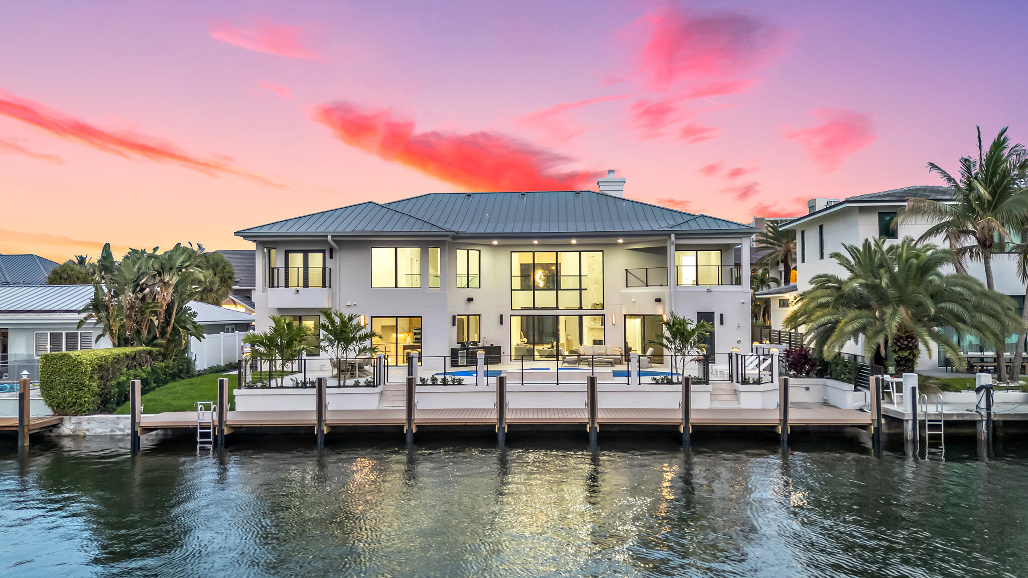 Welcome to one of the most sought after waterfront homes for sale in South Florida located in Lighthouse Point's prestigious Venetian Isles. For boating enthusiasts, this property features a brand new 90 foot composite dock with direct ocean access and no fixed bridges. The ultimate South Florida lifestyle for buyers searching for luxury waterfront living, boating properties, deep water dock homes, and move in ready homes near Fort Lauderdale and Boca Raton. This 7 Bedroom, 6 Bathroom home has been completely upgraded with designer finishes and modern systems throughout. Inside, you are welcomed by white oak engineered hardwood floors and rectified porcelain tile across the first level, creating a clean, modern coastal aesthetic that today's buyers are actively searching for.  The open concept layout is enhanced with linear AC vents, solid hardwood interior doors, and a fully integrated Control4 smart home system, pre wired for whole home audio, security cameras, and a smart doorbell, delivering the smart luxury home experience buyers expect. The chef's kitchen is designed for both everyday living and entertaining, featuring quartz countertops, dual sinks, and premium Forno appliances including a built in side by side refrigerator and freezer and a wall oven and microwave combo. A dedicated wine cellar adds an elevated touch for those seeking a true luxury home experience. Major upgrades include four new Rheem AC units, new electrical panels, new impact windows and doors, and a brand new irrigation system with professionally designed landscaping. The exterior has been completely re stuccoed and enhanced with a marble paver driveway and sleek aluminum railings with stainless steel cable detailing, delivering strong curb appeal for buyers searching for modern waterfront homes. Step outside to your private resort style backyard featuring a newly upgraded saltwater pool system with heater and a fully equipped outdoor kitchen with sink and refrigerator, ideal for entertaining and enjoying year round South Florida sunshine. This property aligns perfectly with buyers searching for deep water homes, yacht friendly properties, and waterfront homes with dock in South Florida. Additional highlights include an ultra capacity washer and dryer with a convenient laundry chute, adding functionality to this high end home. This is a rare opportunity to own a fully renovated, smart home waterfront property in Lighthouse Point, one of the most desirable coastal communities in South Florida. Perfect for buyers relocating to Florida, luxury home buyers, investors, and those searching for waterfront homes near Fort Lauderdale, Boca Raton, and Miami.