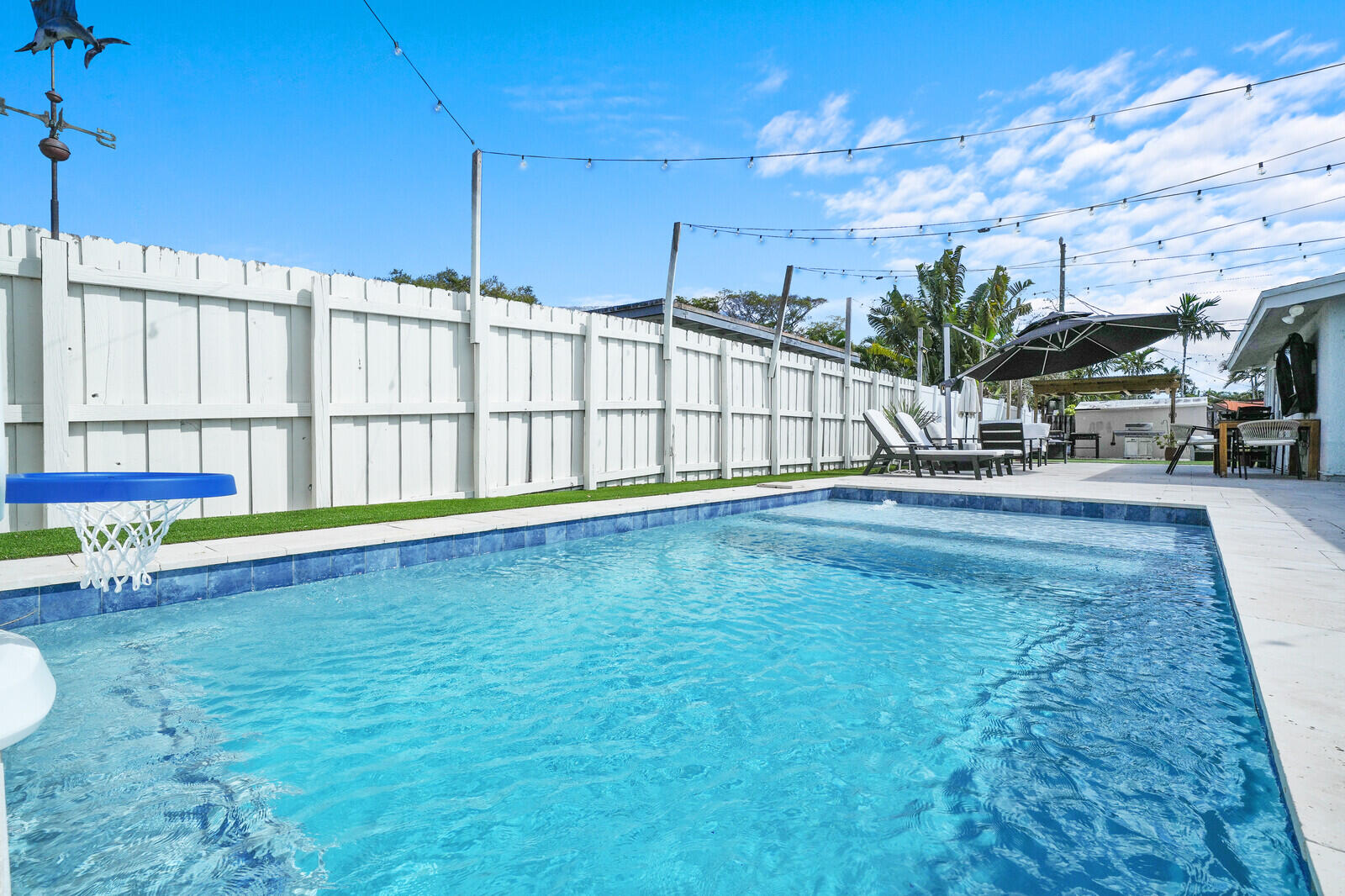 Updated 3BR/2BA home in Wilton Manors on a spacious 7,700 SF corner lot. Features include impact windows & doors, large concrete driveway, and 2-car garage with smart lift system. Interior offers fresh paint, bar area/dining room, large walk-in pantry, and Nest thermostat. Major updates include new AC (2021), flat roof (2024), electrical subpanel (2023), instant electric water heaters, and mostly updated PVC plumbing. Enjoy a private backyard oasis with a new pool (2023) featuring splash pad & umbrella holder, hot tub, 1,000 SF travertine deck, 365 SF artificial turf, and covered grilling area. Includes 11x12 shed and double-wide gates on both sides for boat/RV storage. Low-maintenance landscaping and move-in ready!