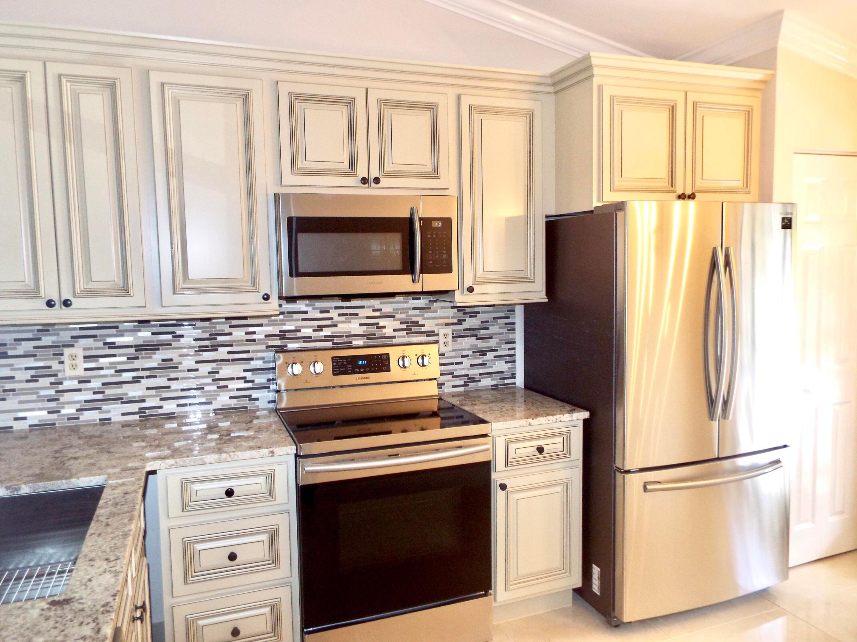 Welcome to this Charming Totally Renovated two-bedroom, two-bathroom condominium in Lucerne Park Condos, located in Greenacres, Florida. This two-story residence offers 1,059 square feet of Tastefully finished living space. This Unit Comes With Porcelain Tiled Floors Throughout, Freshly Painted in a Neutral Colour, Custom Kitchen Cabinetry , SS Appliance Pkg, Tiled Bathrooms With Frameless Shower Doors providing a comfortable Living Experience.  The well-proportioned layout features a Large Living Area & an Oversized Primary Bedroom Suite.  The Development Is Set in A Park Like Setting Surrounded By Beautiful Landscape & Large Lakes With Walking Paths . Conveniently Located near I-95 and The Fla Turnpike. Close To PBI Airport , Major Shopping & Dining.