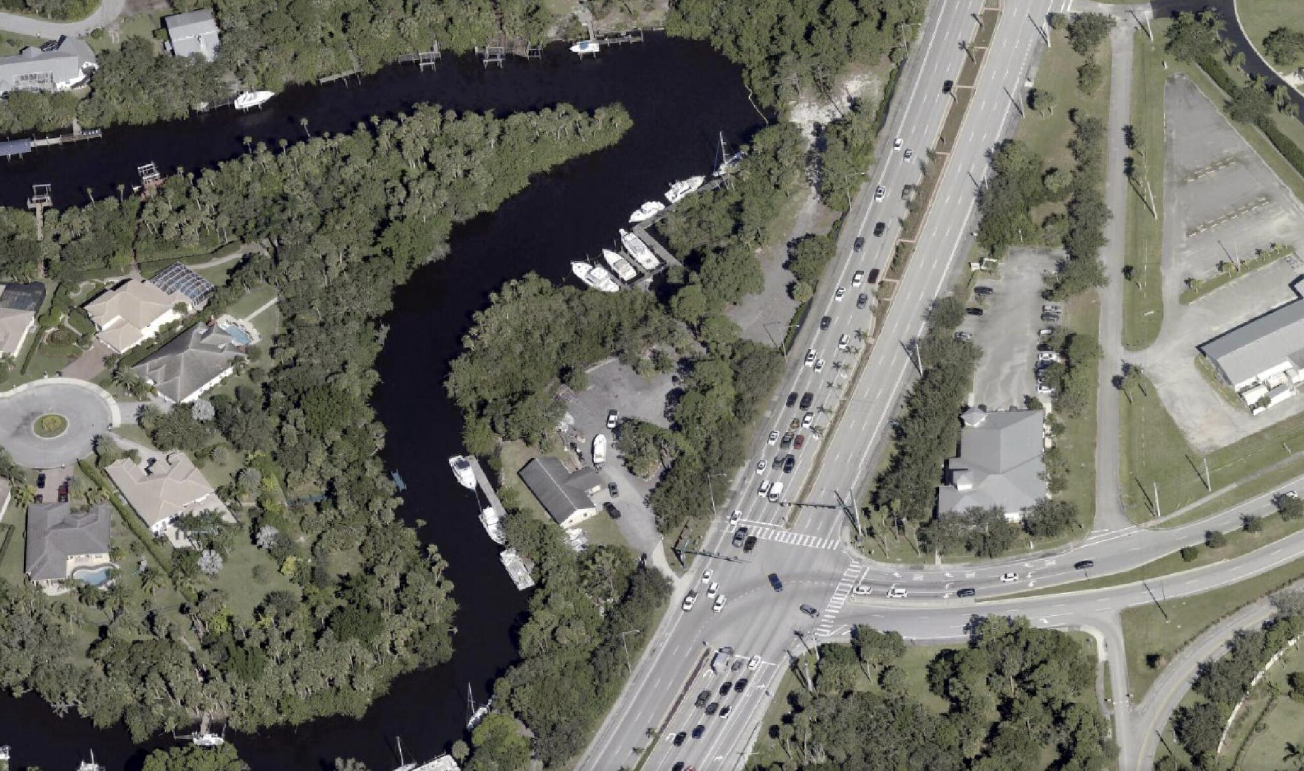Discover 2.55 acres of prime commercial waterfront property with direct access to the St. Lucie River. Located at the signalized intersection of Cove Road and S. Kanner Highway, the property offers excellent visibility, approximately 1,200 feet of coastline, deep-water access, multiple boat slips, and two 160-foot floating docks.  The fully fenced site includes a residential structure suitable for office conversion and is ideal for marina operations, marine services, office use, retail, or future redevelopment.