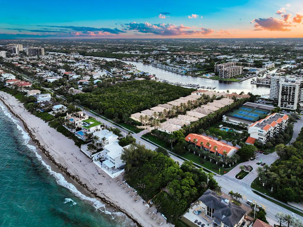 Gated, 355' to deeded beach access and a private 50' dock with boat lift directly on the ICW with ocean access. Welcome to 4042 S Ocean Blvd in Highland Beach, a true south Florida pinnacle retreat. Ocean Cove is a one-of a-kind private gated enclave of only 22 executive homes built with the extreme high quality JH Norman construction is known to deliver. Ideally located between the intracoastal and 355 feet from the front door to the beach, this recently updated pool home is absolutely immaculate and shows like a model. Step in to dramatic high ceilings, polished stone floors, floor to ceiling impact windows, separate living and family rooms to make getting together inside or out a breeze. The heart of the home has been updated with custom 2-tone wood cabinets, stunning extremely durable blue granite, mosaic backsplash with water filler, newer appliances with both natural gas range and electric double oven, farm sink and vegetable sink and an array of 2 islands and a peninsula. The southern rear facing private fenced in back yard has an abundance of covered areas to take in the coastal breeze as well as space to run on the synthetic grass. The updated heated saltwater pool is bathed in sun year round and backs up to a protected nature preserve. Upstairs, the oversized primary suite has dual bathrooms with a shared shower, dual oversized walk in closets totally built out and 2 guest suites. Additional features include an outdoor shower, custom built wine room with Sub-Zero refrigeration, hurricane impact windows and doors throughout, 25 foot ceilings, mud room and natural gas. Ocean Cove is a private gated community with its own gated / deeded beach access and a private marina located on the Intracoastal Waterway between Boca inlet to the south and Boynton and Lake Worth to the north. This home includes slip 13 and already has a boat lift installed.
