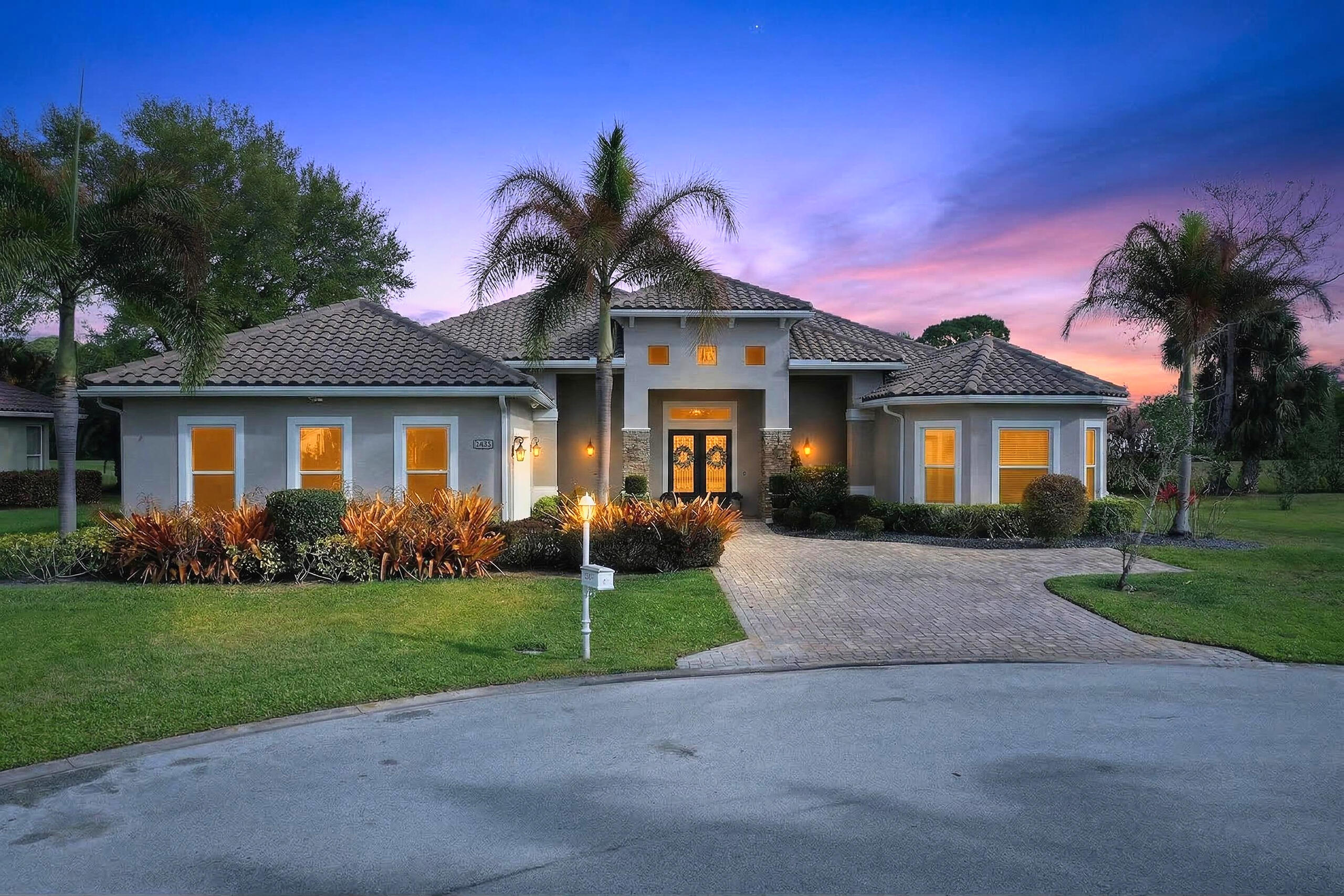 Stunning custom home located on a quiet cul-de-sac in the desirable Country Club Estates community of Port St. Lucie. This 4-bedroom, 3.5-bath residence features elegant architectural details including tray ceilings, a four-way coffered ceiling in the living room, and a 12-foot accent wall with a 75-inch smart electric fireplace. The gourmet kitchen offers a 36-inch KitchenAid five-burner gas range with griddle, pot filler, beverage wine cooler, and a custom walk-in pantry. The spacious primary suite features a freestanding soaking tub, oversized sport shower, and custom closet. Enjoy seamless indoor-outdoor living with zero-edge sliding doors leading to a private backyard with saltwater pool and spa with gas heater. Full Feature Sheet Available!
