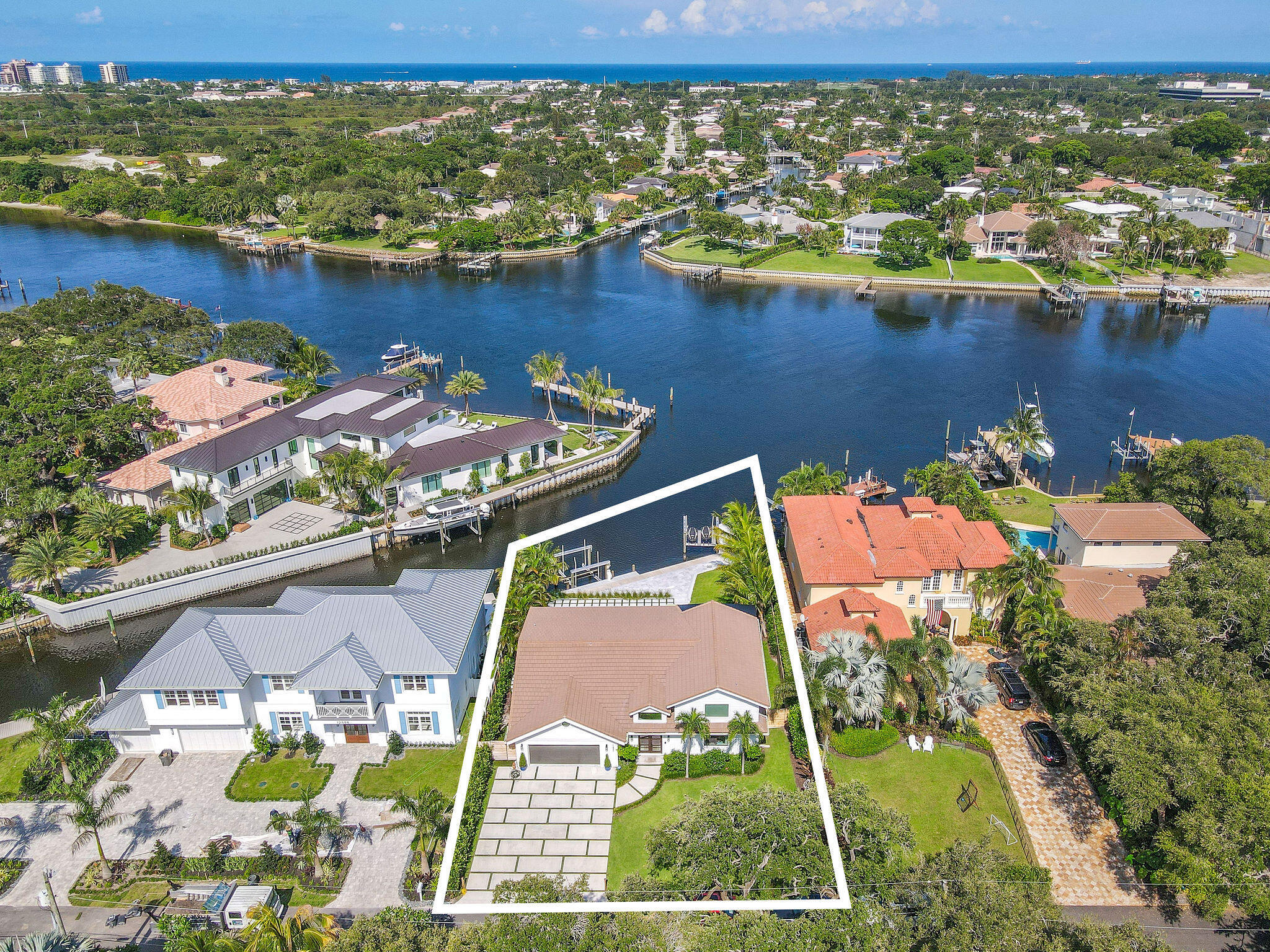 Set on one third of an acre with 90 feet of seawall just off the Intracoastal Waterway, this exceptional waterfront property sits at the end of a private, tree-canopied road. Designed for boating enthusiasts, the property offers deep water dockage for multiple vessels, no fixed bridges, a no wake zone, and both 20,000 lb and 10,000 lb boat lifts installed in 2021. The seawall was replaced in 2022. The professionally designed outdoor space features a new pool, spa, and decking, all positioned to enjoy wide water views. The existing four bedroom, three bath plus den pool home sits above the flood zone and includes over 4,000 square feet under air, including 324 square feet of air conditioned attic space. AC units were replaced in 2021 and the home is equipped with full impact glass. Ideally located on South Shore Drive with a picturesque oak lined approach surrounded by waterfront homes, the property offers convenient access to Juno Beach, shopping, dining, the mall, I-95 and more. A rare waterfront opportunity ready to enjoy.
