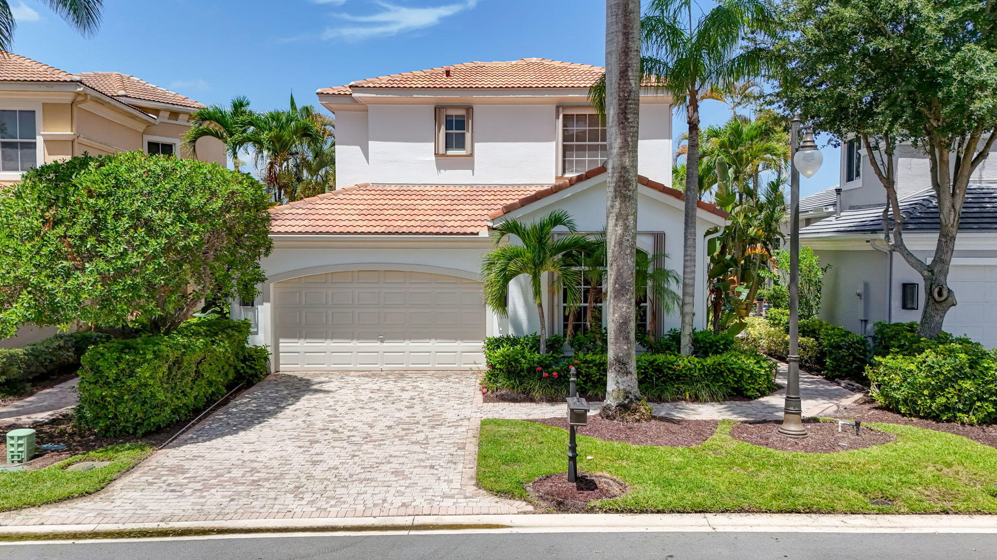 Thoughtfully reimagined and truly one of a kind, this exceptional Dorado model is the epitome of indoor/outdoor living! Located within the prestigious Country Club at Mirasol and offering four bedrooms, three-and-a-half baths, dual first-floor primary suites, and a dedicated home office, this updated residence is the perfect blend of timeless elegance and contemporary design with gorgeous sunset views.  A grand entry welcomes you into light-filled living spaces where soaring ceilings, an open floor plan and designer fixtures\s merge to create an atmosphere of understated luxury. LVF throughout the bedrooms and staircase adds warmth and creates the perfect design for move-in ready living. At the heart of the home, the redesigned kitchen is both beautiful and functional, featuring  quartz countertops, a dramatic waterfall-edge island, premium finishes, and an open layout that seamlessly connecting to the main living and dining areas—ideal for everyday living and gracious entertaining.  The highly desirable, one-of-a-kind floor plan offers two primary suites on the first level, including a private guest retreat (or second primary Bedroom) with a fully renovated en-suite bath showcasing a double vanity, spacious walk-in shower, and refined contemporary finishes. A newly added powder room enhances convenience for guests. Generous closets and abundant storage are found throughout.  Upstairs, two additional bedrooms, a beautifully renovated shared bath, and a spacious loft provide comfortable accommodations for family and guests. Wood-look luxury vinyl flooring throughout the second level creates a cohesive, modern aesthetic.  Designed to embrace South Florida's indoor-outdoor lifestyle, the expansive screened patio overlooks a free-form, salt-chlorinated heated pool framed with sweeping lake views and spectacular sunsets.  Additional features include accordion hurricane shutters, a tankless water heater, and two air conditioning systems replaced in 2020 and 2022, including a dedicated system serving the first-floor guest suite.  A Sports Membership is available, providing access to Mirasol's world-class amenities, including INDOOR and outdoor pickleball courts, Har-Tru tennis courts, two championship golf courses, a state-of-the-art fitness and wellness center, spa services, and multiple exceptional dining venues.  Offering an extraordinary combination of sophisticated design, thoughtful updates, and indoor/outdoor living, this exceptional residence represents a compelling opportunity within Mirasol Country Club.