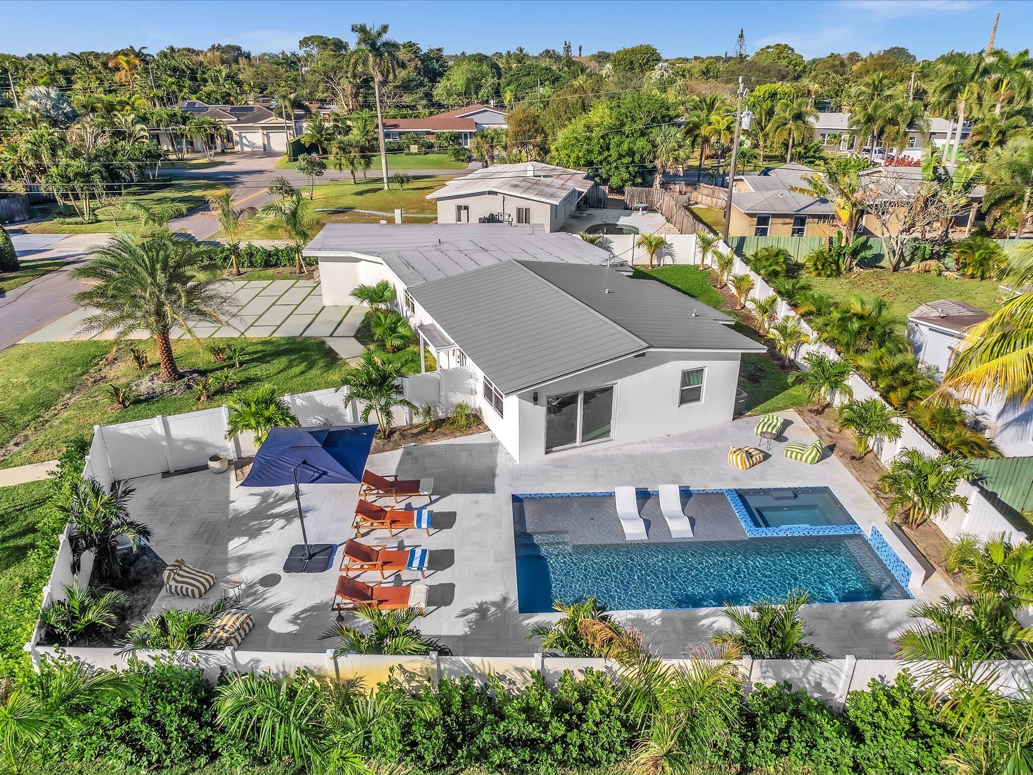 Welcome to this exceptional newly renovated modern luxury 4-bedroom, 3-bathroom residence located in the heart of Wilton Manors. This home offers a perfect blend of style, comfort, and prime location. Situated on a spacious corner lot of 10,650 sq ft, featuring a spacious private backyard with open sky, a heated saltwater pool and spa with a stunning waterfall feature. The large open-air outdoor space and oversized yard provide the perfect setting for entertaining, relaxing, and enjoying the South Florida lifestyle. Prime location close to restaurants and nightlife, just a few blocks from the Drive.