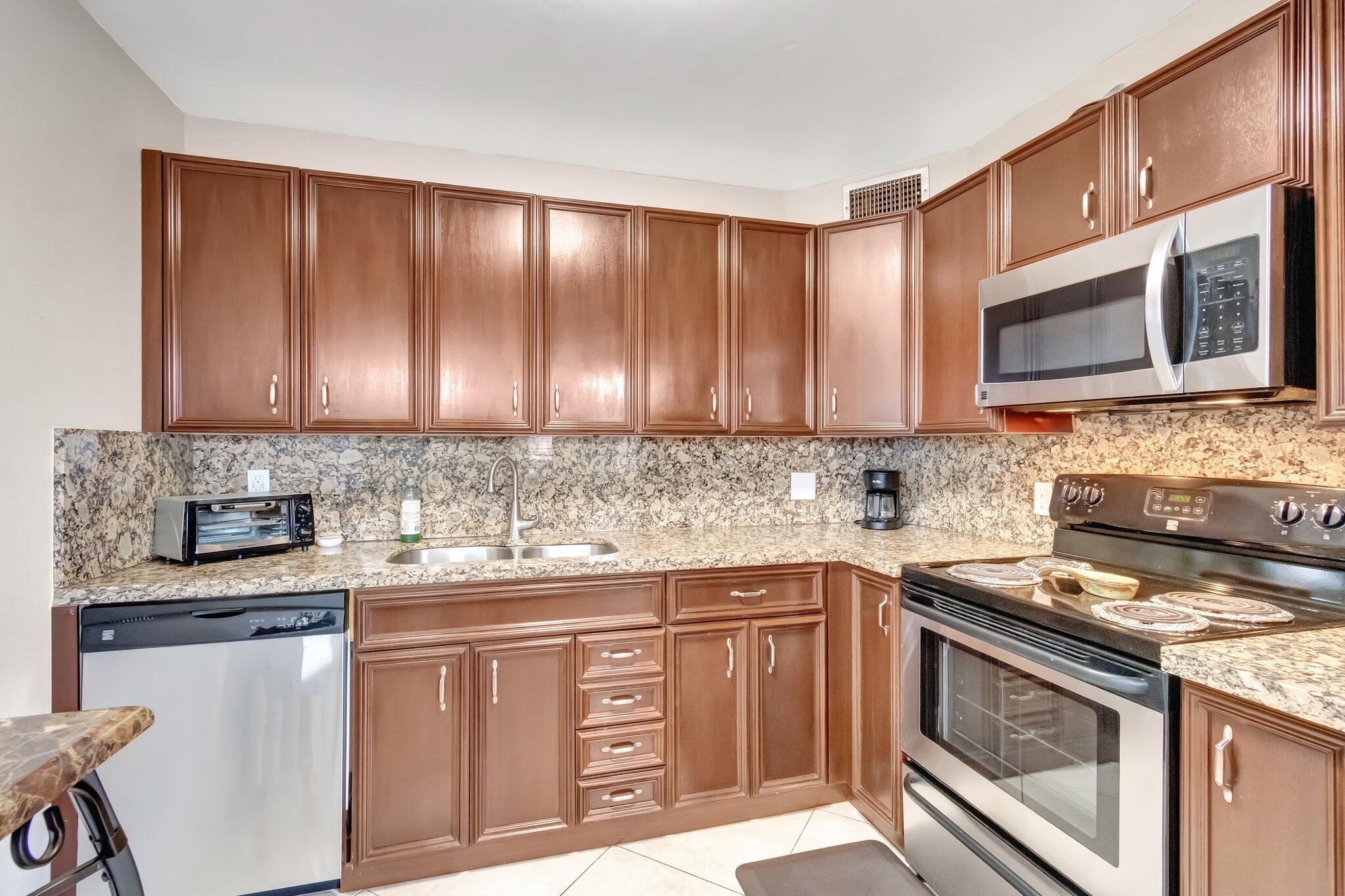 CENTURY VILLAGE, BOCA RATON--SUPER ACTIVE ADULT COMMUNITY.   LOCATION...LOCATION...LOCATION!    RENTABLE FROM DAY 1. BRAND NEW ROOF--2026.  CLOSE TO THE GATE, THE CLUBHOUSE, AND PLACES OF WORSHIP.     TOTAL MONTHLY HOA FEES ARE $832.56 (WATER, BASIC CABLE, INTERNET & WiFi ARE INCLUDED).   This meticulously renovated condominium awaits its new owner in the heart of Boca Raton's Century Village, the Wolverton C area. An advantageous location is an integral part of this condominium's allure, settled across from a serene satellite pool - an emblem of relaxation and a haven for warm Florida days. However, this property's real beauty is found when stepping through its entrance.  An impressive chef's kitchen greets guests with splendor. You'll relish the richness of genuine wood cabinets, contrasting beautifully with sleek granite countertops and a coordinating backsplash. A large, double sink and stainless-steel appliances ensure modern utility meets style, providing an environment poised for culinary staging.  Extending throughout the unit are exquisite diagonal floor tiles that seamlessly bridge the space between rooms while offering long-lasting durability and easy upkeep. Plush carpeting in two rooms provides a gentle underfoot experience, delivering comfort without compromising style.  Intricate storage systems within generously built-in closets ensure personal items are neatly and efficiently stowed. Consequently, each room maintains a clean, uncluttered appearance, contributing to the overall living experience.  Each room comes with the bonus of a private entrance to a screened, plexiglass-enclosed patio - a perfect vantage point for soaking up the awe-inspiring panoramic lake view. Matching diagonal tiles underfoot pulls the interior aesthetic outdoors, ensuring a seamless transition between spaces.  Ascending to this top-floor unit is a journey to an overlook that can only be described as breathtakingly beautiful. Layered with panoramic expanses of water, the view becomes a living and dynamically changing painting with each passing hour. Every social gathering held within or outside this delightfully situated condo would undeniably impress, painting a memorable picture against the backdrop of the lake view. It's not just a place to live; it's a lifestyle that can be lived to its fullest.  Residents can enjoy top-notch amenities. The Century Village includes 105 residential buildings, 2 Synagogues, a Clubhouse and Theater, 17 outdoor swimming pools, 1 indoor pool, 12 tennis courts, bocce, pickleball courts, shuffleboard, fishing, and more. Residents can access various amenities, including classes, clubs, a library, meeting rooms, a party room for club or condominium association functions, a fitness center, and a billiards room. The clubhouse has WiFi, and live entertainment is available year-round in a 1,252-seat theater. Additionally, current movies are shown several times each week.   This beautiful, ethically designed condominium is a testament to grace, functionality, and a heartening take on Floridian living. If you seek a property that blurs the lines between home and holiday, you've found it.   THE CONDO COULD BE OFFERED FULLY FURNISHED OR NOT.