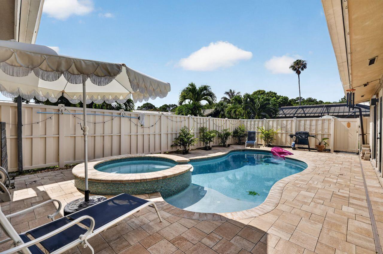 Welcome to this beautifully updated 3-bedroom, 2-bath townhome in the heart of Palm Beach Gardens. Featuring soaring vaulted ceilings, luxury vinyl plank flooring, and a bright open floor plan with desirable southeast exposure, this home offers comfortable Florida living with a low HOA. The updated kitchen boasts granite countertops, stainless steel appliances, subway tile backsplash, and ample cabinetry. Enjoy your own private heated pool and spa. Major updates include a metal roof (2018) and full replacement of polybutylene plumbing (2025). Residents enjoy two community pools, clubhouse, playground, walking paths, and sidewalks throughout. Ideally located near Alton Dog Park, Juno Beach, Roger Dean Chevrolet Stadium, tennis and pickleball center, Downtown at the Gardens, and The Gardens Mall, with easy access to dining, shopping, golf, boating, paddle boarding, I-95, and Florida's Turnpike.