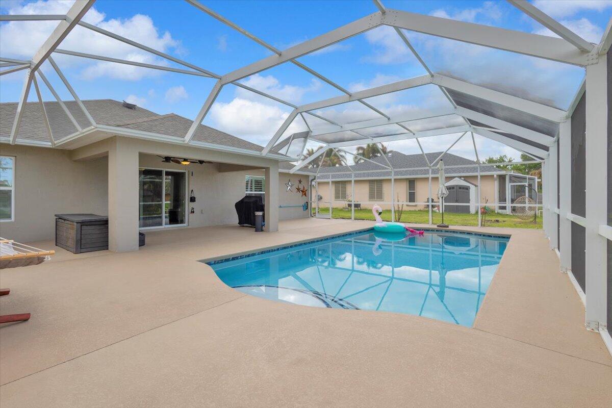 Discover your private oasis with this CBS 2021 built home with No HOA and 3 car garage - so bring your extra toys, RV, boat, or ample cars! This inviting 3-bedroom, 2-bathroom saltwater pool home sits on a tranquil canal-front lot, offering a peaceful retreat shaded by mature trees with fruit trees. The interior features a spacious split floor plan with vaulted ceilings, custom plantation shutters on all windows, formal living and dining areas, and a large primary suite complete with a Roman tub and dual sinks. An office/den may be used for the front room - Fiber internet is available with AT&T! Featuring an expansive screened porch and an oversized saltwater pool that is fully operational from your phone with lights and therapy jets, perfect for entertaining in the Florida sun!
