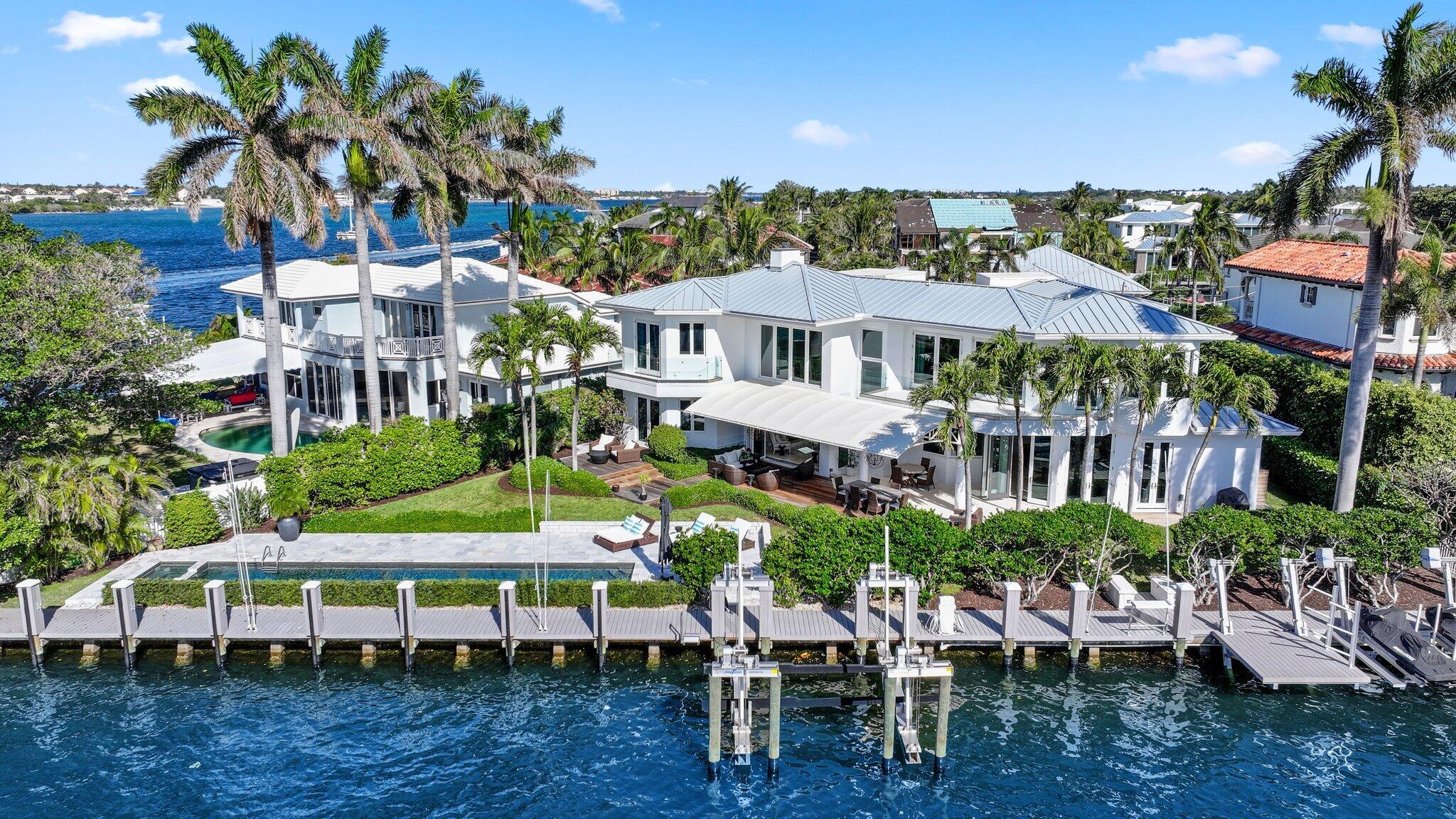 This outstanding 5 Bedroom 3.5 Bath contemporary waterfront sanctuary perfectly blends modern luxury with the ultimate Florida lifestyle. Boasting 166 feet of protected deep water dockage with wide Intracoastal views, it is just seconds to the Boynton Beach Inlet.

Step inside through a custom mahogany door and be immediately captivated by breathtaking Intracoastal views. The spacious living room features soaring volume ceilings and a stunning gas/wood-burning fireplace, creating a warm and inviting atmosphere. Designed with impeccable attention to detail, this home seamlessly blends elegance and functionality. The chef's kitchen is a culinary dream, equipped with top-of-the-line appliances, including a Sub-Zero refrigerator/freezer and a Miele 8-burner gas range with double ovens. A walk-in pantry with an additional refrigerator and a climate-controlled wine room complete this entertainer's paradise. Adjacent to the kitchen, the casual family room offers unobstructed water views, making it the perfect spot to relax or host guests.

This home features five luxurious bedrooms, including a show stopping primary suite upstairs. The primary suite boasts two custom walk-in closets, a spa-inspired bath with a soaking tub, and a wraparound balcony with panoramic Intracoastal views. Two additional upstairs bedrooms each feature private balconies, while two main-level guest suites provide privacy and comfort for visitors.
The outdoor spaces are truly exceptional. A 50-foot heated saltwater pool anchors the backyard, surrounded by multiple seating areas ideal for entertaining. For boaters, the property offers a 60,000-pound boat lift, jet ski lifts, an electric paddleboard/kayak lift, and a full-service dock with water and electric connections. With its close proximity to the Boynton Beach Inlet, ocean access is just minutes away.

Additional features include all-new impact windows and doors, a 2-year-old roof, a central vacuum system, a Sonos speaker system, and three zones of AC for optimal comfort.
As a resident of McCormick Mile, you'll enjoy exclusive access to a private oceanfront beach club with stunning Atlantic views. Conveniently located near Palm Beach International Airport, Worth Avenue, and The Royal Poinciana Plaza, this home offers the perfect blend of luxury and lifestyle.

Key Features:

Grand Entrance: Custom mahogany door, soaring ceilings, and gas/wood-burning fireplace with stunning Intracoastal views.

Chef's Kitchen: Sub-Zero refrigerator/freezer, Miele 8-burner gas range with double ovens, walk-in pantry with refrigerator, and climate-controlled wine room.

Bedrooms: Five total, including a primary suite with wraparound balcony and spa-like bath, two upstairs bedrooms with private balconies, and two main-level guest suites.

Outdoor Living: 50-foot heated saltwater pool and multiple seating areas for entertaining.

Boating Amenities: 60,000-pound boat lift, jet ski lifts, electric paddleboard/kayak lift, full-service dock with water and electric connections.

Upgrades: All-new impact windows and doors, 2-year-old roof, central vacuum, Sonos speaker system, and three AC zones.

Beach Club Access: Exclusive membership to McCormick Mile's private oceanfront beach club with parking and breathtaking views.


Prime Location: Minutes to the Boynton Beach Inlet, close to Palm Beach International Airport, Worth Avenue, and The Royal Poinciana Plaza.