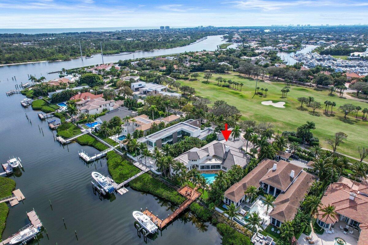 Welcome to this exquisite Mediterranean waterfront estate in the prestigious Admirals Cove community. Boasting 100 feet of prime waterfrontage and a brand-new 50,000 lb-rated boat lift, this home is a boater's paradise with deep-water access. Designed for luxurious living and grand entertaining, this 6-bedroom, 8 full-bath, and 2 half-bath estate offers elegant finishes, soaring ceilings, and breathtaking water views throughout. The expansive layout is perfect for hosting, featuring two grand sitting rooms overlooking the water, a full movie theater, a stately library, and two custom-designed wet bars. The private elevator provides easy access to the movie theater and an executive office with stunning waterfront views. A sprawling screened-in sunroom creates the perfect setting for outdoor gatherings, seamlessly blending indoor and outdoor living. The home is equipped with top-tier amenities, including a 2021 roof, Flow Logic safety water shut-off system, and a home generator connected to gas lines with automatic turn-on for uninterrupted power. The resort-style pool, recently resurfaced, offers a true oasis, while the spacious 3.5-car garage provides ample parking and storage. For added versatility, a private 2-bedroom, 2-bathroom guest apartment complete with a full kitchen, living area, and seperate entrance serves as the perfect in-law suite or luxury guest retreat. Situated in one of South Florida's most exclusive waterfront communities, this entertainer's dream home offers unparalleled elegance, comfort, and sophistication.