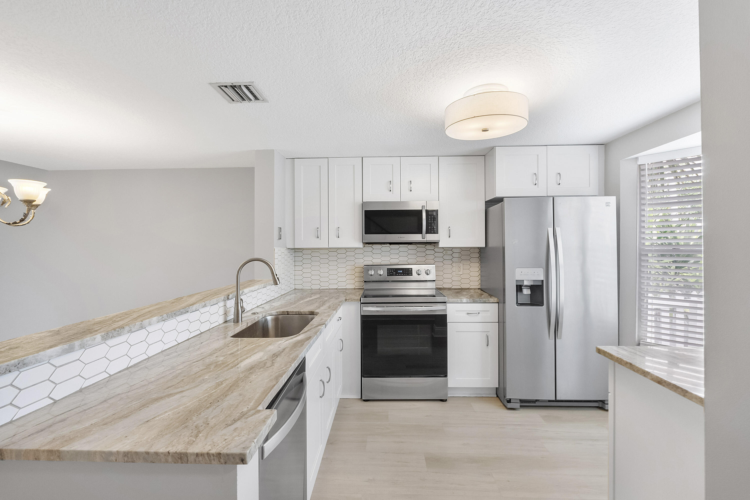 Back on the market: Updated Townhome in East Pompano Beach - best deal for a fee simple townhouse only 2 miles to the beach! Great location across the street from Publix & walk to many great restaurants. Newly remodeled Kitchen tastefully designed w/ white shaker cabinets, Quartzite counters & stainless steel appliances, Luxury Vinyl Flooring, Waterview & much more!  Private patio overlooking the pond. Half-bath on first floor. Double master/primary bedrooms upstairs. Amazing restaurants nearby and only 2.5 miles to the Pompano Beach Pier!  **No Polybutylene pipes! Full replacement with a City of Pompano permit**. All ages welcome. Large pets welcome with a maximum of two dogs per unit. Two car limit per unit. Rent right away - an investors dream! Minimum lease 4 months.