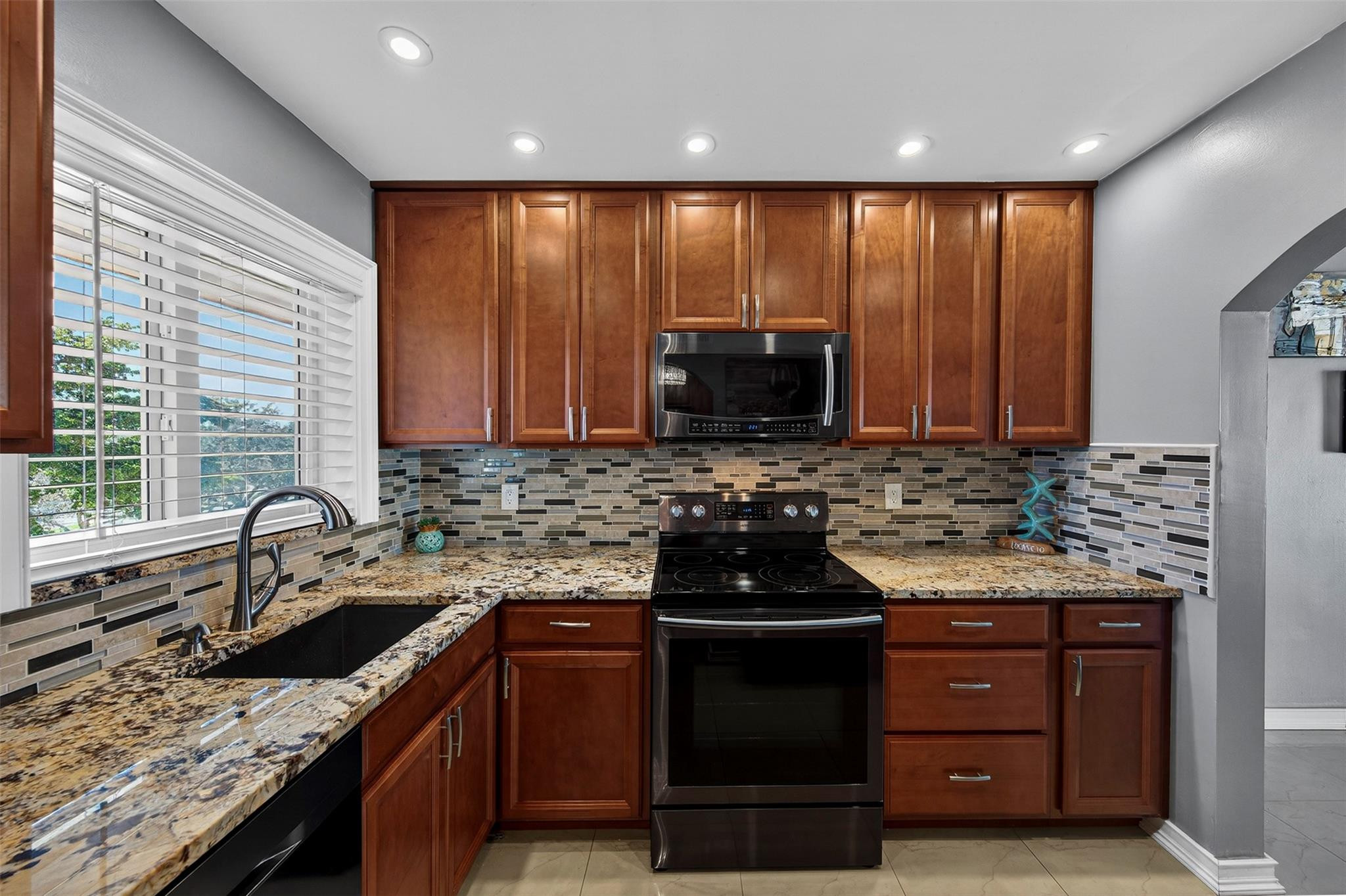 Welcome to this beautifully remodeled 2-bedroom, 2-bath condominium located in a desirable 55+ community in the heart of Sunrise. This move-in-ready unit features top-of-the-line Samsung appliances, wood cabinets, elegant countertops, modernized bathrooms, impact windows, and stylish tile flooring throughout. Enjoy breathtaking lake views that create a peaceful and relaxing atmosphere from your living space.Residents have access to a variety of amenities, including a sparkling swimming pool, tennis courts, and shuffleboard, making this community ideal for an active and social lifestyle. Don’t miss this rare opportunity to own a beautifully updated unit in a well-maintained and welcoming community.