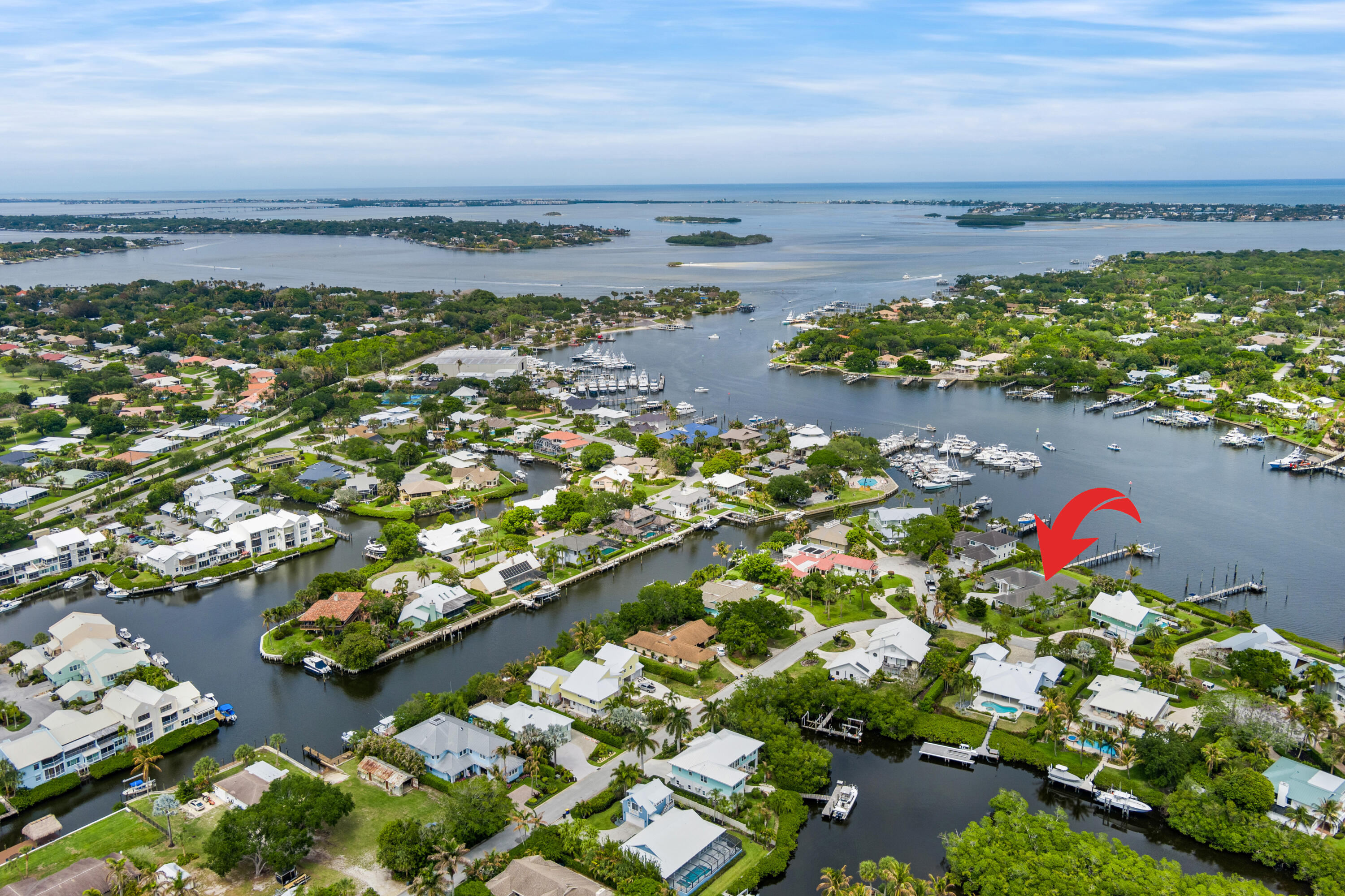 Welcome to the one you've been waiting for. Built in 2022, this exceptional waterfront residence showcases luxury living with state-of-the-art upgrades throughout. Perfectly situated in the gated community of Mariner Cay, within the highly sought-after Manatee Pocket, this property offers both exclusivity and premier boating access—just minutes to the inlet. Positioned on wide water with desirable eastern exposure, enjoy breathtaking sunrises each morning while relaxing in a backyard designed for comfort in the cooler afternoon shade. The private dock provides ample space to accommodate a large yacht, making this an ideal haven for boating enthusiasts seeking safe harbor waters.  A rare opportunity to own a newer construction waterfront home in one of the most coveted boating communities.