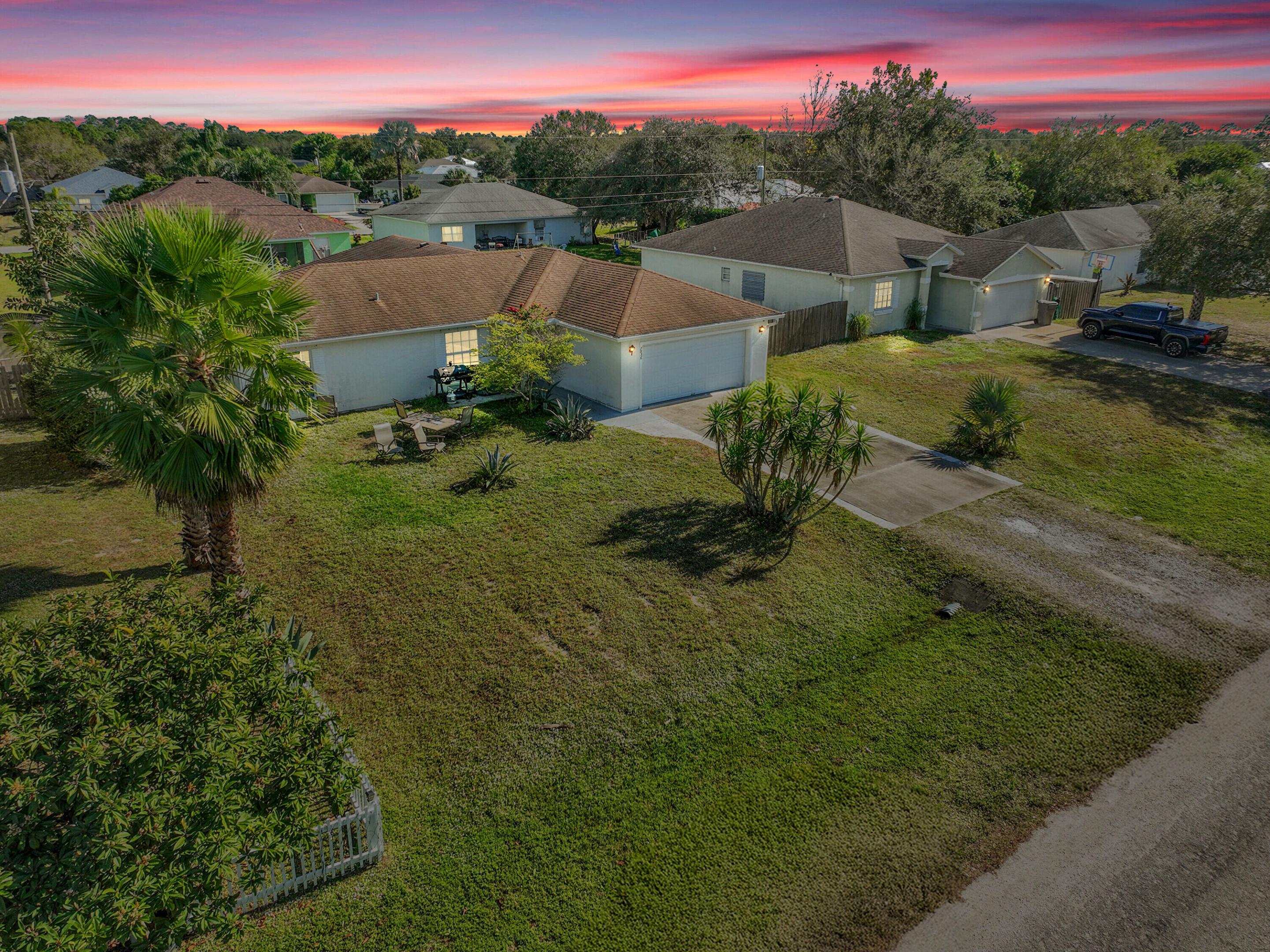 Welcome to this charming 3-bedroom, 2.5-bath split-plan home in desirable Vero Lake Estates. This home is minutes away from beaches, dining, and riverfront attractions. Major updates include a brand new roof and newly installed fence, offering immediate value, improved insurability, and long-term peace of mind. Inside, enjoy vaulted ceilings, tile flooring throughout, and a kitchen ideal for entertaining. The expanded family room opens to a screened lanai with an outdoor bath, perfect for indoor-outdoor living. The spacious primary suite features dual walk-in closets. Formal living and dining rooms plus a laundry room with sink complete the home.