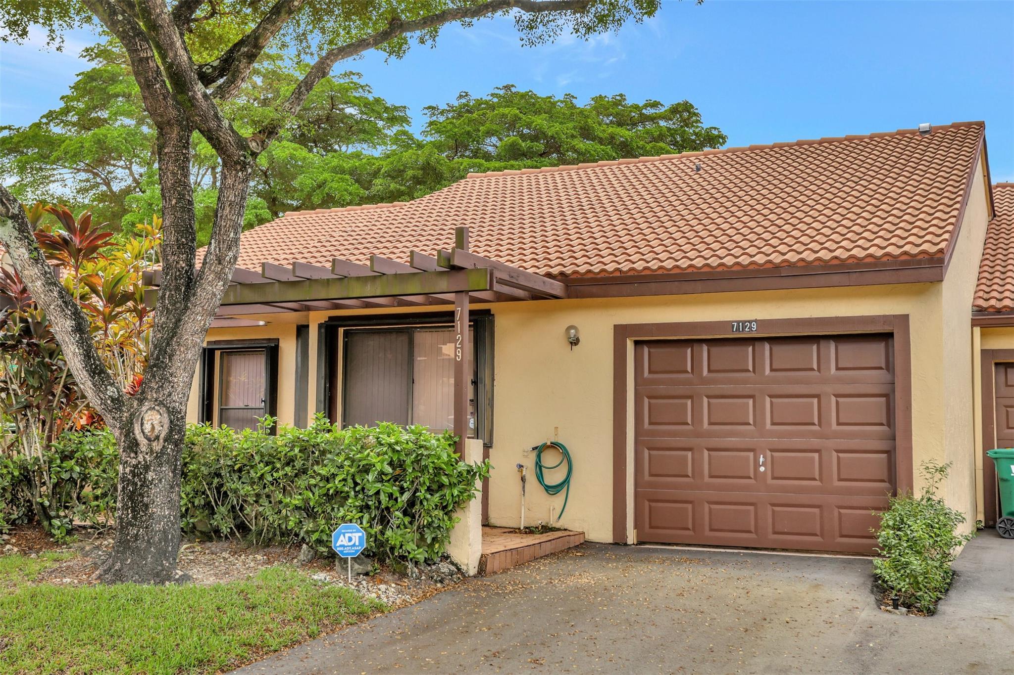 This is the one you have been waiting for!  Nestled away in the BEAUTIFUL community of Brookwood Gardens in Lake Colony is a large, open and spacious villa.  The home features 2 large bedrooms PLUS a den which can easily be used as a third bedroom. Soaring high ceilings make this home feel larger than it is.  An attached one car garage makes this feel like you are living in a single family home. Conveniently located off of University Drive near major highways, restaurants and a community hospital. FULL Hurricane Protection.  HOA  covers all roof repairs and maintenance, lawn, a community pool and building painting.  All ages welcome and pet friendly.  Being sold fully furnished and equipped. Completely move in ready with just a few cosmetic updates to really make it your own. AS IS Sale